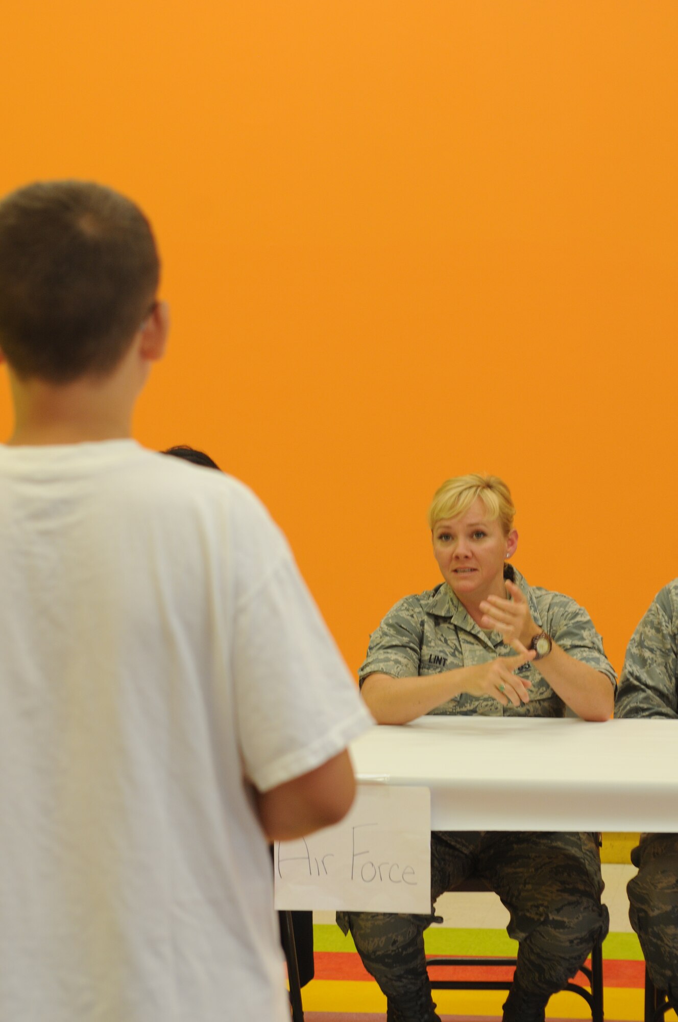 Tech. Sgt. Kalee Lint, Development and Training Flight program manager and executive assistant to the command chief for the 910th Airlift Wing, answers a student’s question on Air Force service during an engagement at Kidz by the Riverside, a daycare in Warren, Ohio, June 26. Students at the daycare’s summer program crafted thank you cards, signs and goody bags to present to public service personnel. To receive the gifts and answer questions about their careers, the daycare invited three Airmen, a sailor and a Marine from Youngstown Air Reserve Station, along with two soldiers from Warren’s Army Recruiting Center, a local firefighter and a detective from the Trumbull County Sheriff’s office. U.S. Air Force photo/Eric M. White.