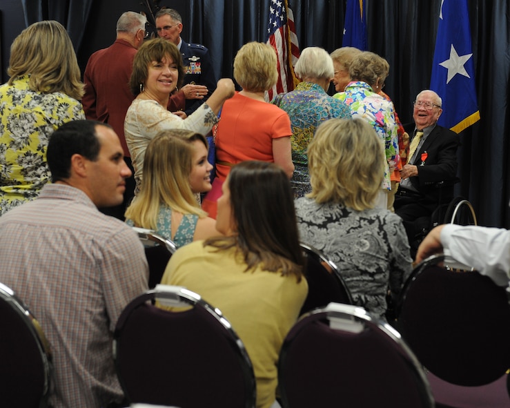 Friends and family congratulate John Carpenter, a World War II veteran, right, after being presented the French Legion of Honor for his service during World War II on Barksdale Air Force Base, La., July 1, 2014. Carpenter participated in the Invasion of Normandy and the Battle of the Bulge as a logistics Soldier. Carpenter, 29 during D-Day, was much older than the soldiers around him. His experience was valuable to the war effort and soldiers around him. (U.S. Air Force photo/Senior Airman Benjamin Gonsier)