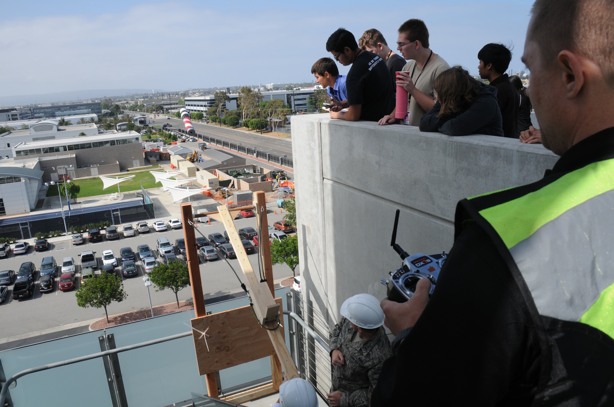 Students from five local area high schools teamed up with Space and Missile Systems Center mentors atop of the Los Angeles AFB, 7th floor parking lot, where they launched payloads and recorded flight data and or went back to the drawing board to make improvements, Jun 16, 2014. The STEM event is part of the SMC 60th Anniversary as the six teams were responsible for “fundamental design practices to... develop imaging and data acquisition payloads to be launched from the roof of the parking garage. Students were responsible for designing, building, integrating and testing electronics packages into a bus structure capable of surviving launch, flight and recovery. A small parachute will be deployed from each payload to increase time aloft to gather data. Data and imagery will be acquired and judges will evaluate the payloads on functionality, structural integrity and aesthetics”. (Photo by Joe Juarez)