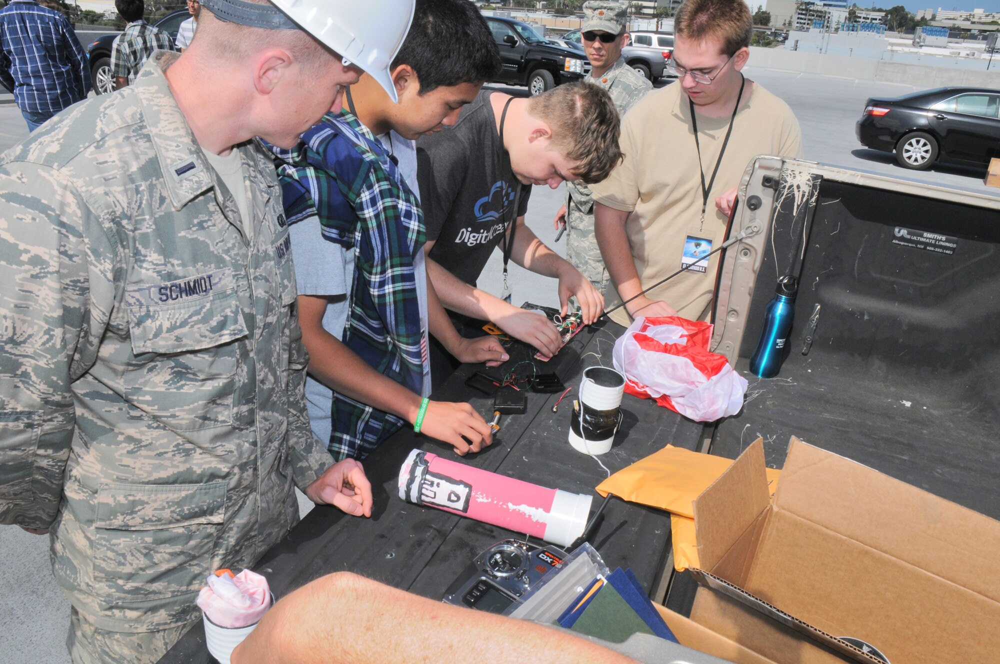 Students from five local area high schools teamed up with Space and Missile Systems Center mentors atop of the Los Angeles AFB, 7th floor parking lot, where they launched payloads and recorded flight data and or went back to the drawing board to make improvements, Jun 16, 2014. The STEM event is part of the SMC 60th Anniversary as the six teams were responsible for “fundamental design practices to... develop imaging and data acquisition payloads to be launched from the roof of the parking garage. Students were responsible for designing, building, integrating and testing electronics packages into a bus structure capable of surviving launch, flight and recovery. A small parachute will be deployed from each payload to increase time aloft to gather data. Data and imagery will be acquired and judges will evaluate the payloads on functionality, structural integrity and aesthetics”. (Photo by Joe Juarez)