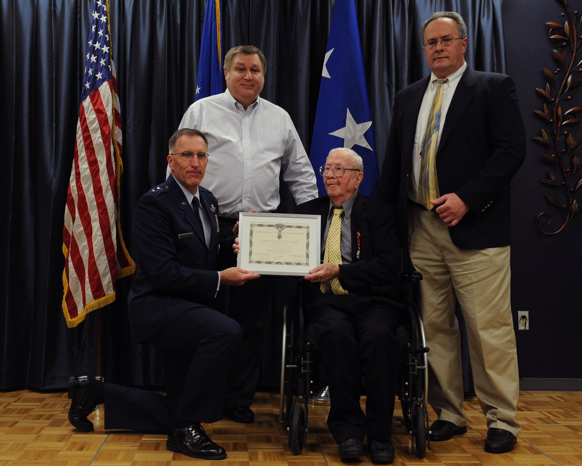 John Carpenter, a World War II veteran, is presented a certificate after receiving the French Legion of Honor from Maj. Gen. Scott Vander Hamm, 8th Air Force commander, on Barksdale Air Force Base, La., July 1, 2014. The Legion of Honor is one of the highest recognitions an individual can receive from the French government. While there is a limit to how many awards can be presented, an exception was made for service members who fought on French soil during World War II. (U.S. Air Force photo/Senior Airman Benjamin Gonsier)