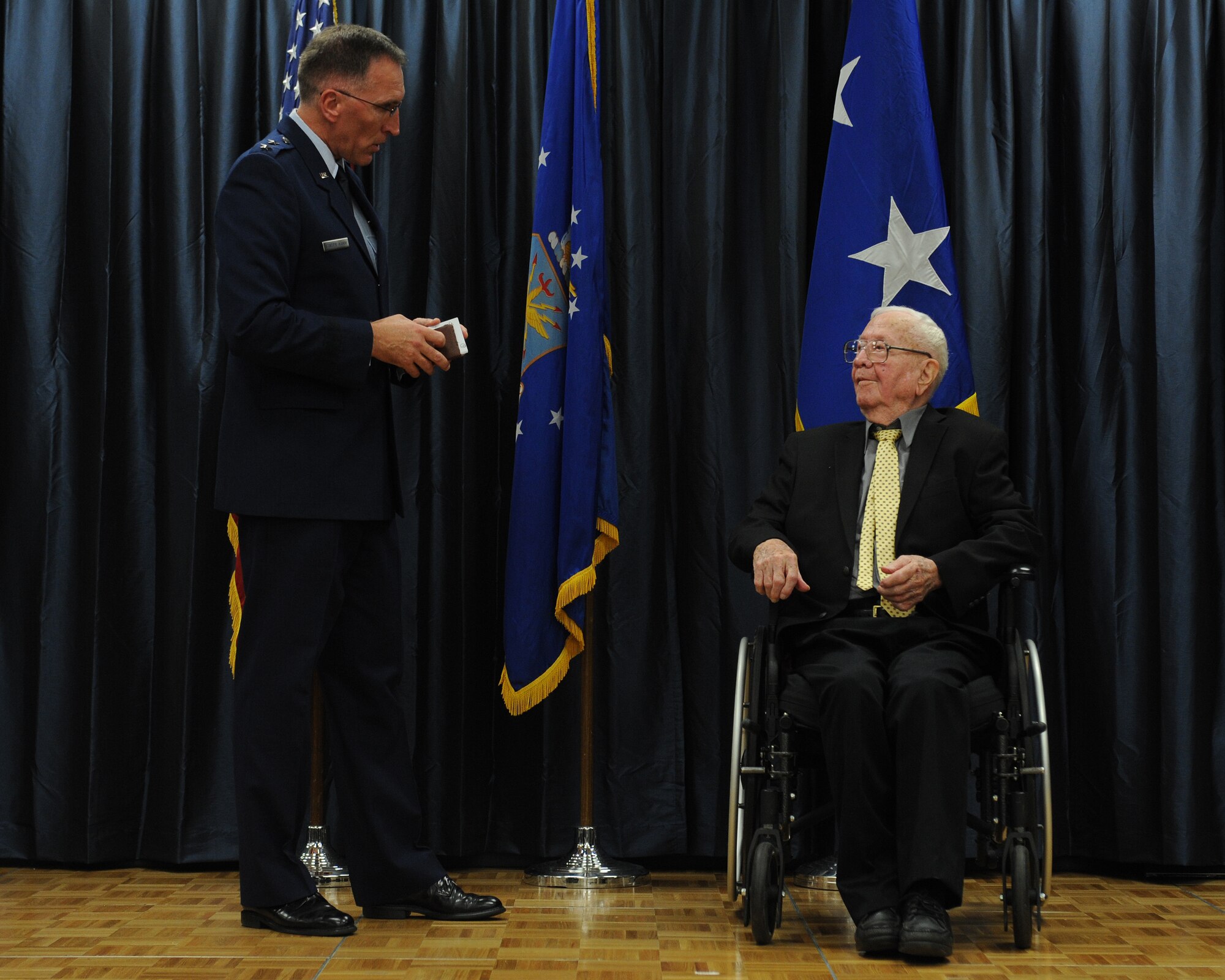 Maj. Gen. Scott Vander Hamm, 8th Air Force commander, speaks to John Carpenter, a World War II veteran, during an award presentation on Barksdale Air Force Base, La., July 1, 2014. Carpenter received the French Legion of Honor for his service during World War II, which included his participation in D-Day and the Battle of the Bulge. (U.S. Air Force photo/Senior Airman Benjamin Gonsier)