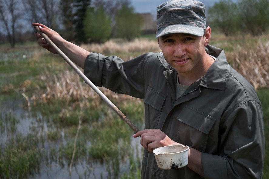 Senior Airman Nathaniel Boober, 5th Civil Engineer Squadron insect control, inspects an area of standing water for mosquito larvae on Minot Air Force Base, May 19, 2014. Once Boober tallies the area’s most likely to breed mosquitoes, he can more effectively prevent the spread of the pest throughout the base. (U.S. Air Force photos/Airman 1st Class Lauren Pitts) 