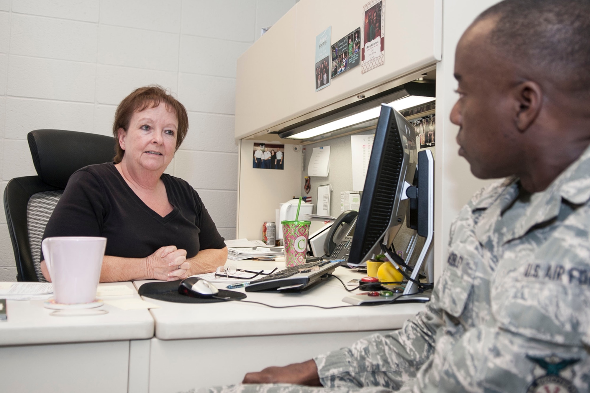 Christy Kimmons, Reserve military pay technician at the 307th Bomb Wing, assists a customer in the military pay office June 2, 2014. The Military Pay office is responsible for paying all Reserve members when they complete their annual tours, special tours, inactive duty training, and Unit Assembly Training (UTA) weekends and numerous other military evolutions. (U. S. Air Force photo by Master Sgt. Jeff Walston/Released)