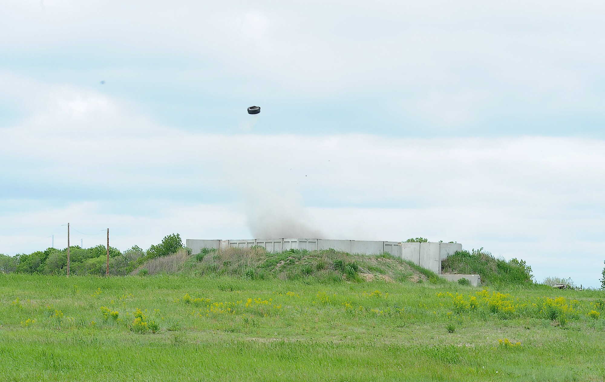 Members of the 5th Civil Engineer Squadron explosive ordinance disposal team, conduct explosives training at Minot Air Force Base, N.D., June 11, 2014. The team used dynamite to conduct tests and improve procedures for handling explosive materials. The EOD team assists in deployed locations with the disarming and detection of improvised explosive devices, and is able to respond to similar situations state-side. (U.S. Air Force photos/ Senior Airman Kristoffer Kaubisch)
