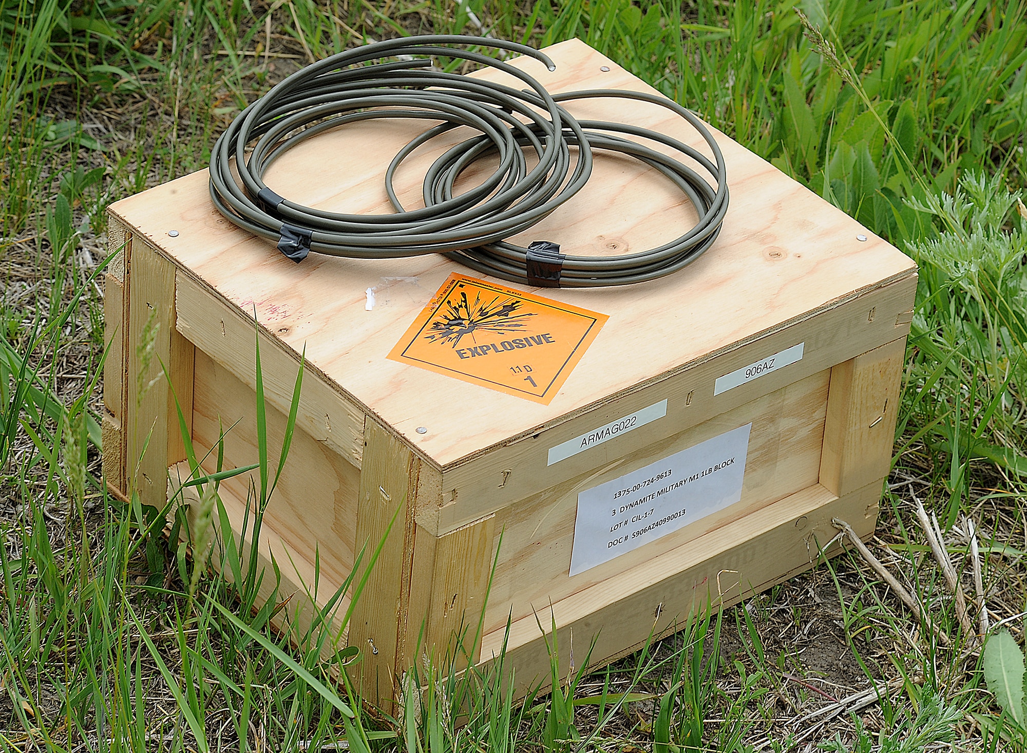 Members of the 5th Civil Engineer Squadron explosive ordinance disposal team, conduct explosives training at Minot Air Force Base, N.D., June 11, 2014. The team used dynamite to conduct tests and improve procedures for handling explosive materials. The EOD team assists in deployed locations with the disarming and detection of improvised explosive devices, and is able to respond to similar situations state-side. (U.S. Air Force photos/ Senior Airman Kristoffer Kaubisch)