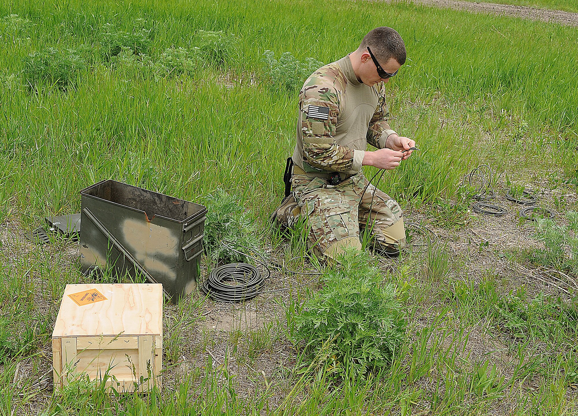 Members of the 5th Civil Engineer Squadron explosive ordinance disposal team, conduct explosives training at Minot Air Force Base, N.D., June 11, 2014. The team used dynamite to conduct tests and improve procedures for handling explosive materials. The EOD team assists in deployed locations with the disarming and detection of improvised explosive devices, and is able to respond to similar situations state-side. (U.S. Air Force photos/ Senior Airman Kristoffer Kaubisch)
