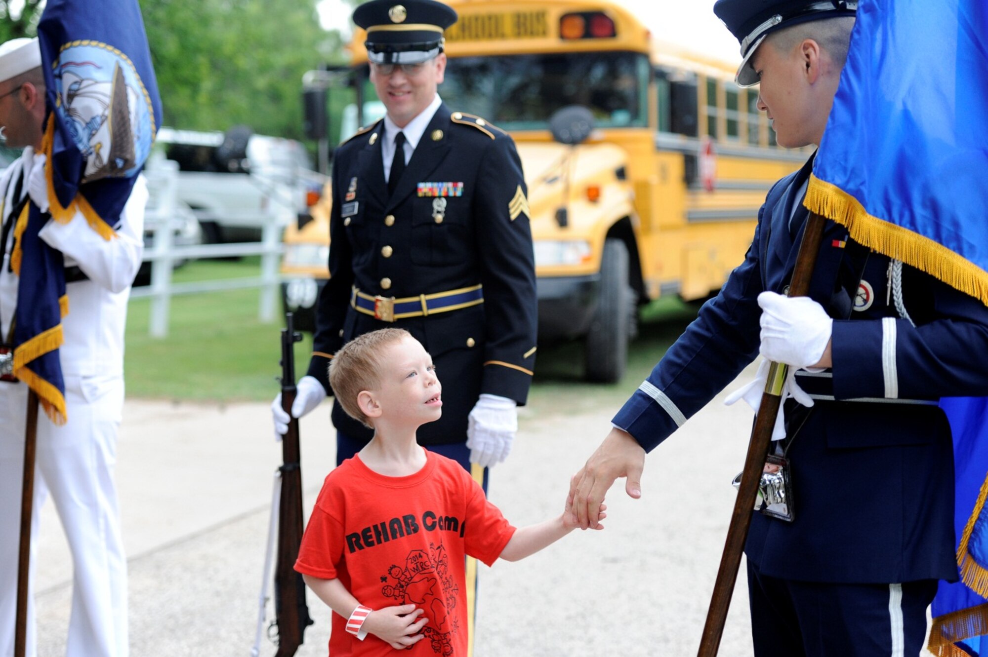 SAN ANGELO, Texas – A camper from the West Texas Rehabilitation Center Summer Camp for Children with Disabilities meets the Goodfellow Air Force Base Color Guard after performing the opening flag ceremony on the Barnhart Family Farm located at Lake Nasworthy June 24.  The Goodfellow Color Guard has opened the camp for the last six years as a way to instill a sense of patriotism in all of the campers. (U.S. Air Force photo/ Staff Sgt. Austin Knox)
