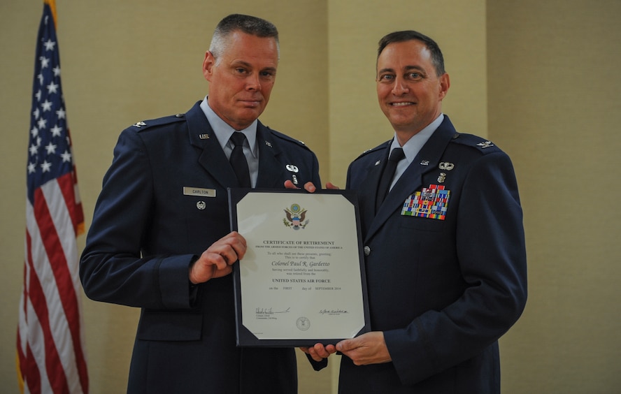 U.S. Air Force Col. Charles Carlton,(left) Air Combat Command deputy command surgeon, and Col. Paul Gardetto, former 23d Medical Group commander, pose for a photo at Moody Air Force Base, Ga., June 30,2014. Carlton was the presiding officer for Gardetto during his retirement ceremony. (U.S. Air Force photo by Airman 1st Class Alexis Millican/Released)