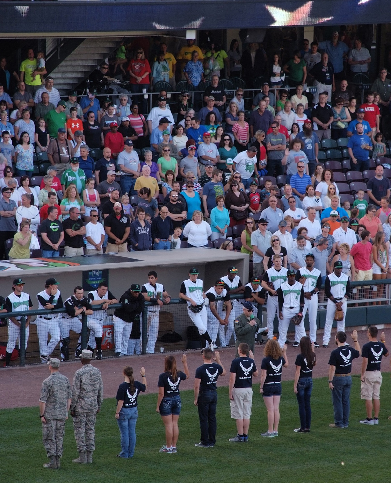 WRIGHT-PATTERSON AIR FORCE BASE, Ohio – Col. Jeffrey McGalliard, 445th Airlift Wing commander, swears in 15 new Air Force recruits during the June 14 Hometown Heroes celebration held during the Dayton Dragons baseball game at Fifth Third Field, Dayton, Ohio. The Dayton Dragons in conjunction with the Dayton Development Coalition annually hosts two Hometown Heroes events at the ballpark to honor servicemen and women associated with Wright-Patterson Air Force Base and the Springfield Air National Guard Base. The Dayton Dragons are a Class A minor league baseball team affiliated with the Cincinnati Reds. (Courtesy photo)
