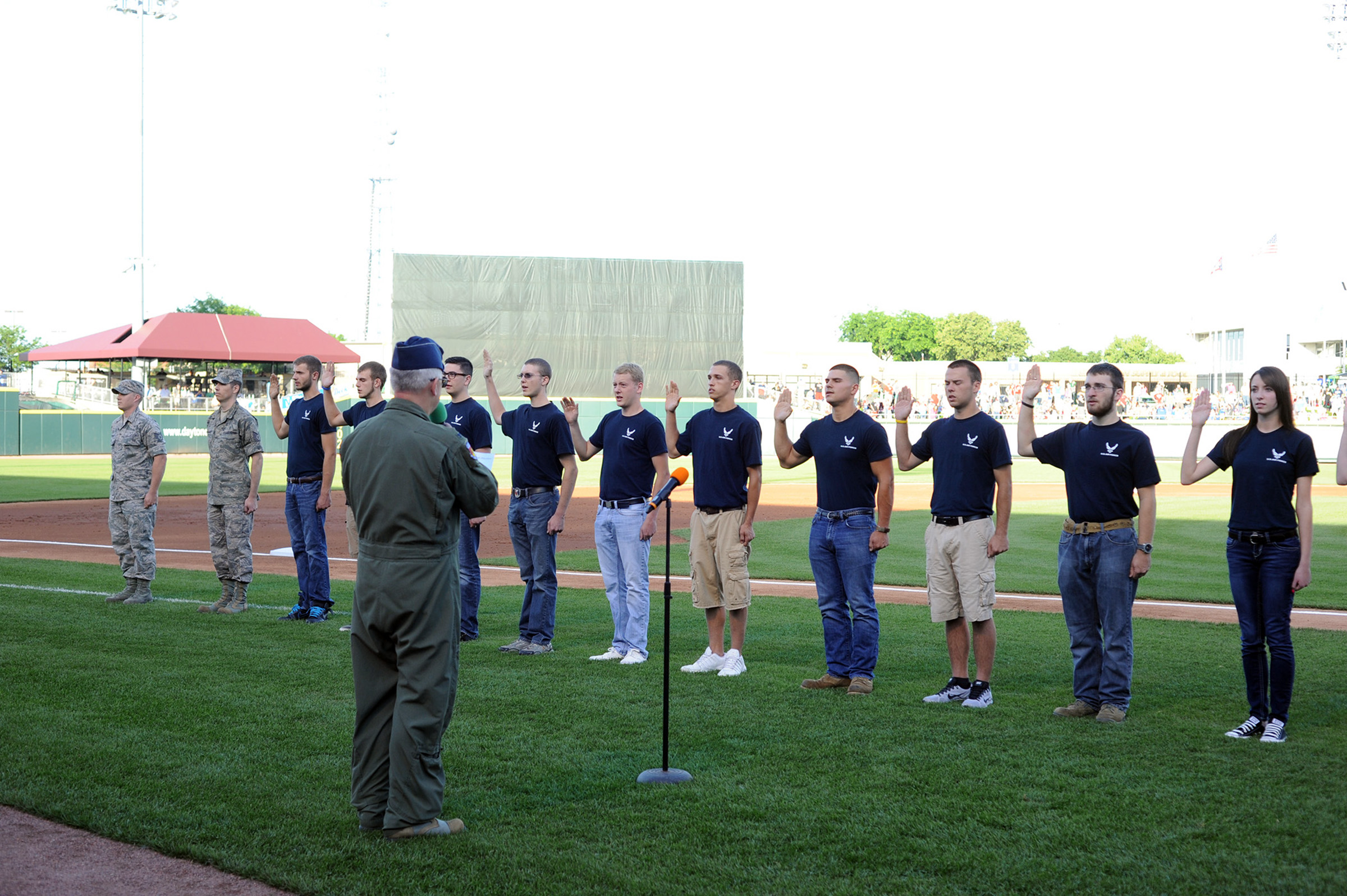 WRIGHT-PATTERSON AIR FORCE BASE, Ohio – Col. Jeffrey McGalliard, 445th Airlift Wing commander, swears in 15 new Air Force recruits during the June 14 Hometown Heroes celebration held during the Dayton Dragons baseball game at Fifth Third Field, Dayton, Ohio. The Dayton Dragons in conjunction with the Dayton Development Coalition annually hosts two Hometown Heroes events at the ballpark to honor servicemen and women associated with Wright-Patterson Air Force Base and the Springfield Air National Guard Base. The Dayton Dragons are a Class A minor league baseball team affiliated with the Cincinnati Reds. (Courtesy photo)