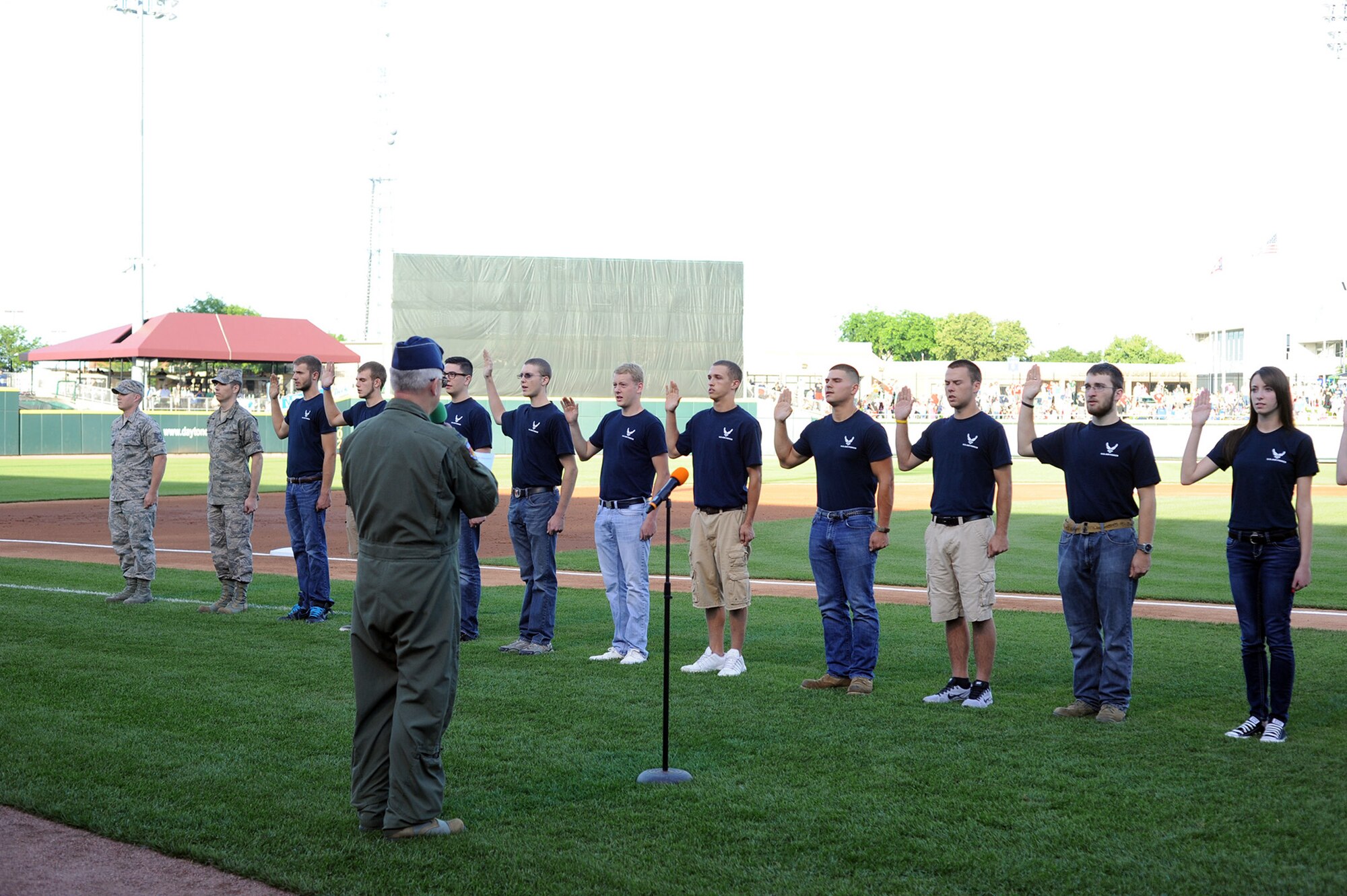 WRIGHT-PATTERSON AIR FORCE BASE, Ohio – Col. Jeffrey McGalliard, 445th Airlift Wing commander, swears in 15 new Air Force recruits during the June 14 Hometown Heroes celebration held during the Dayton Dragons baseball game at Fifth Third Field, Dayton, Ohio. The Dayton Dragons in conjunction with the Dayton Development Coalition annually hosts two Hometown Heroes events at the ballpark to honor servicemen and women associated with Wright-Patterson Air Force Base and the Springfield Air National Guard Base. The Dayton Dragons are a Class A minor league baseball team affiliated with the Cincinnati Reds. (Courtesy photo)