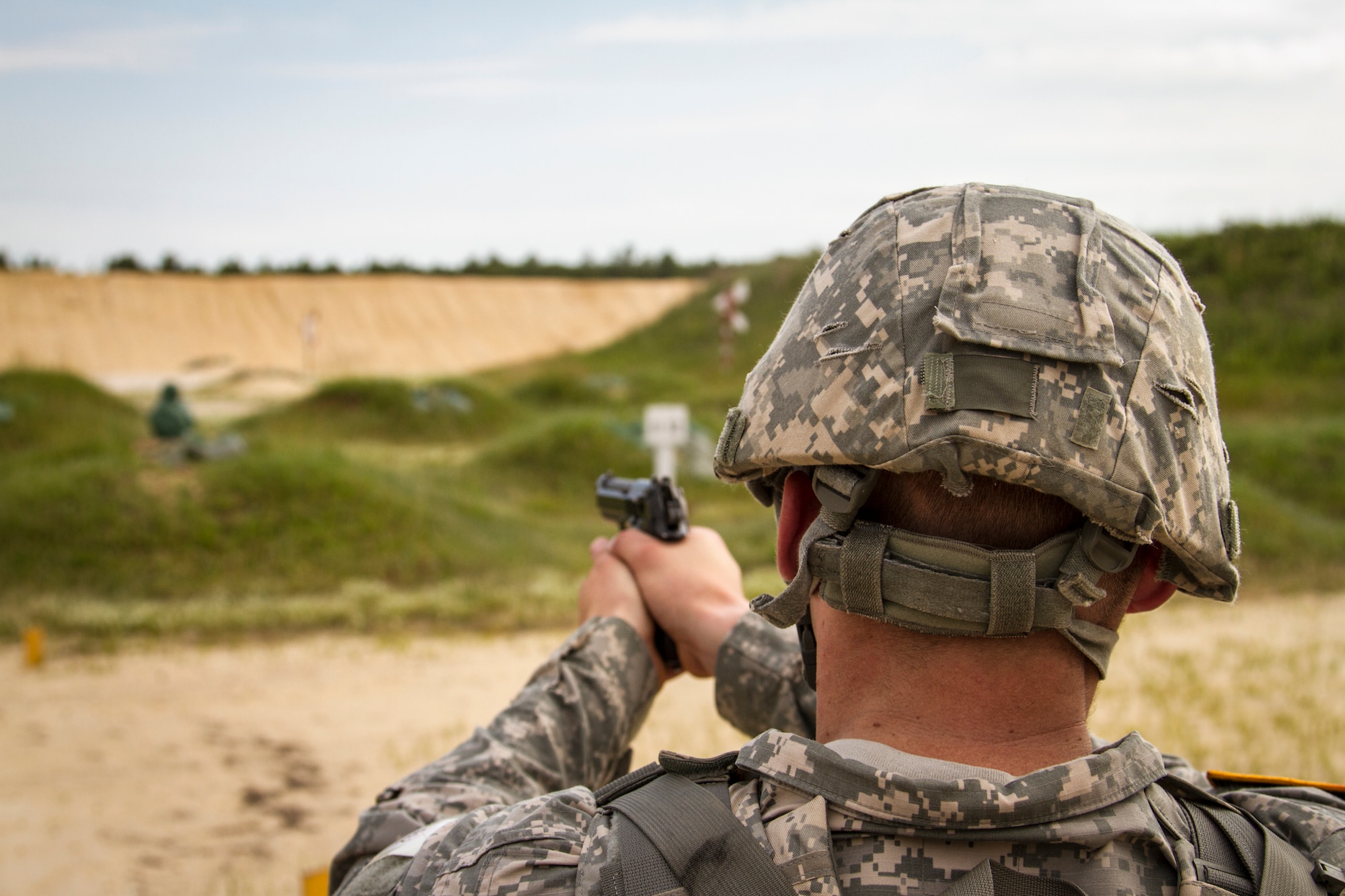 Spc. Keegan Carlson, a civil affairs specialist from Colorado Springs, Colo., with the 440th Civil Affairs Battalion, shoots at the 9 mm qualification range during the 2014 Army Reserve Best Warrior Competition at Joint Base McGuire-Dix-Lakehurst, N.J., June 23. (U.S. Army photo by Sgt. 1st Class Ryan C. Matson/Released)