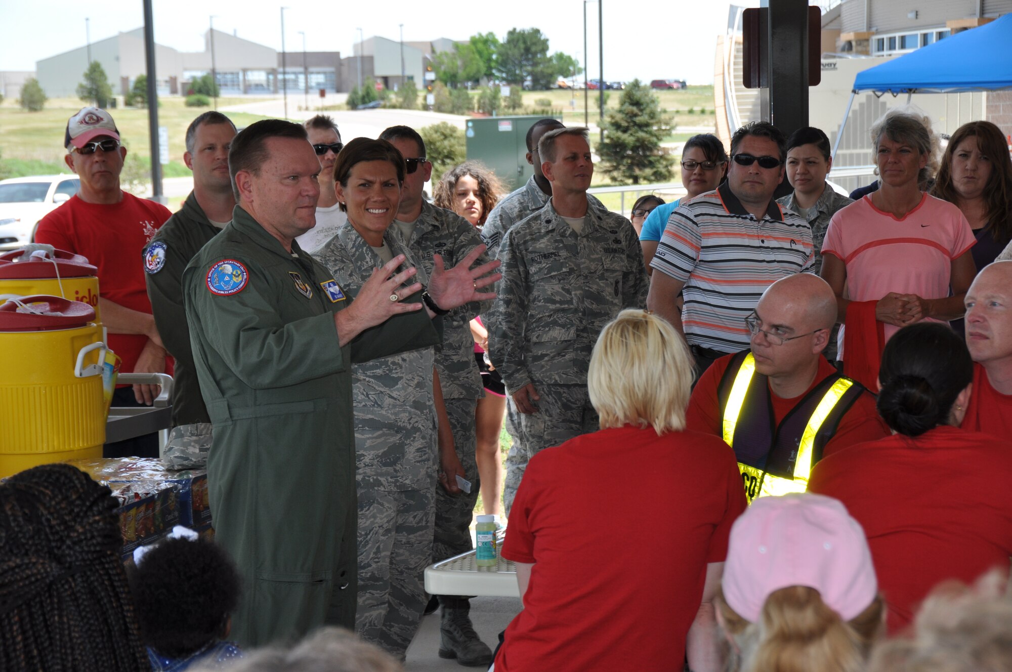 Brig. Gen. Samuel “Bo” Mahaney, Air Reserve Personnel Center commander, and Chief Master Sgt. Ruthe Flores, ARPC command chief, speak to more than 150 service members, civilians and their families during the ARPC commander's fitness and funfest June 30, 2014, at Buckley Air Force Base, Colo. (U.S. Air Force photo/Tech. Sgt. Rob Hazelett)