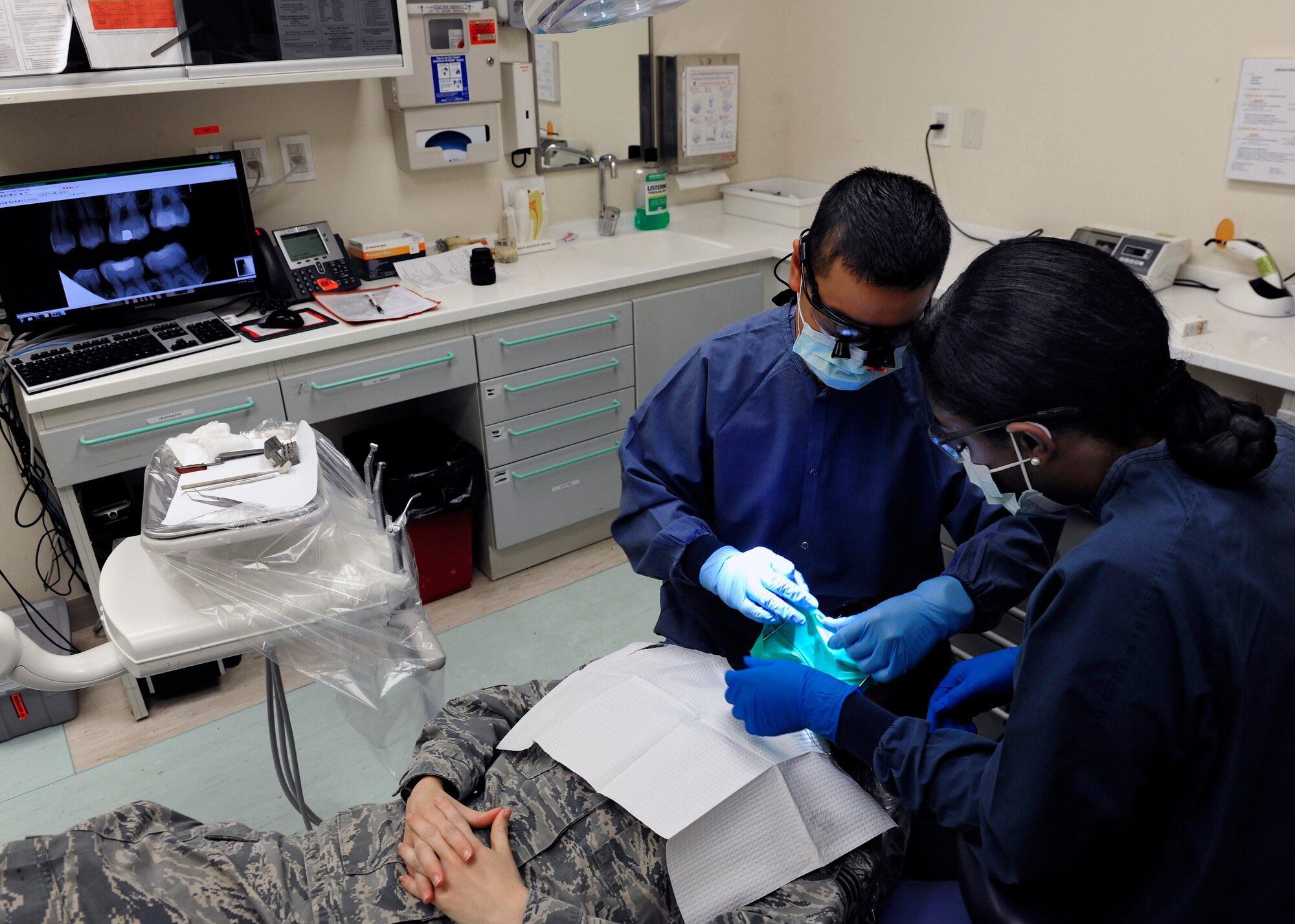 31st Dental Squadron personnel clean a patient’s teeth during an annual checkup, June 19, 2014, at Aviano Air Base, Italy. The 31st Dental Squadron’s primary duties are to treat patients and provide dental care to approximately 9,200 beneficiaries spanning three geographically-separated units under a space-available mission. (U.S. Air Force photo/Airman 1st Class Ryan Conroy) 