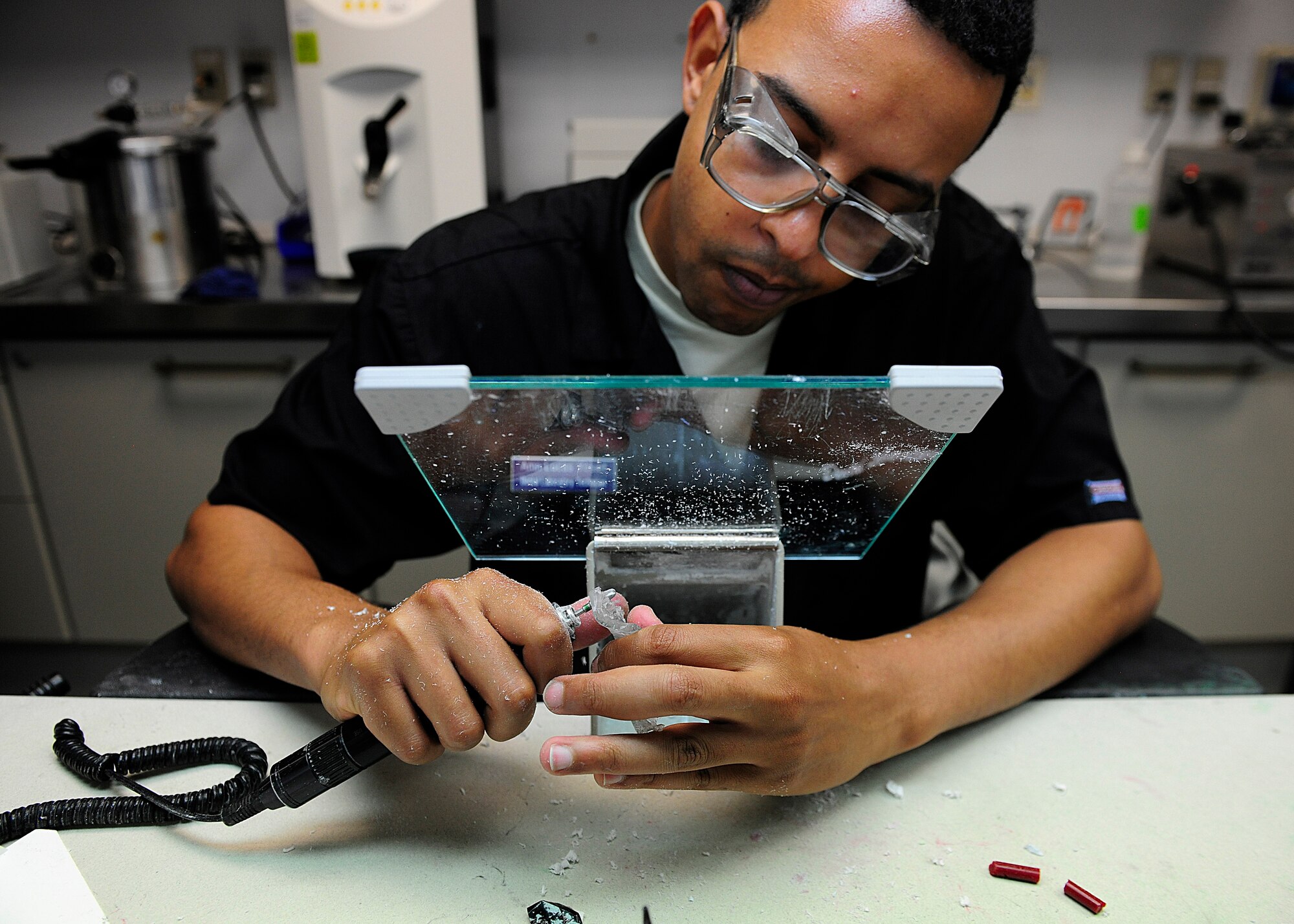 Senior Airman Lucas Yosief , 31st Dental Squadron laboratory technician, forms a new retainer, June 19, 2014, at Aviano Air Base, Italy. The dental laboratory fabricates dental prosthesis for patients on base that include crowns, bridges, retainers and mouth guards. (U.S. Air Force photo/Airman 1st Class Ryan Conroy) 