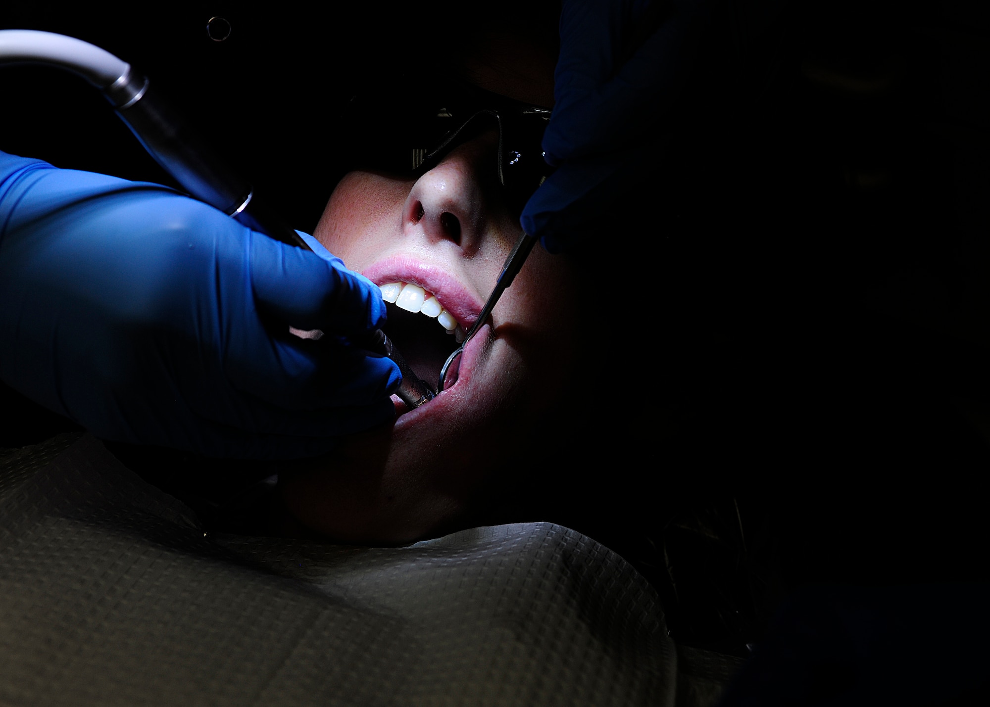 Senior Airman Patricia Gregg, 724th Air Mobility Squadron, receives a routine cleaning during an annual checkup, June 19, 2014, at Aviano Air Base, Italy.  The 31st Dental Squadron’s clinical flight is highly visible and deals with treating patients and providing direct care through the dental clinic and surgeries. (U.S. Air Force photo/Airman 1st Class Ryan Conroy)