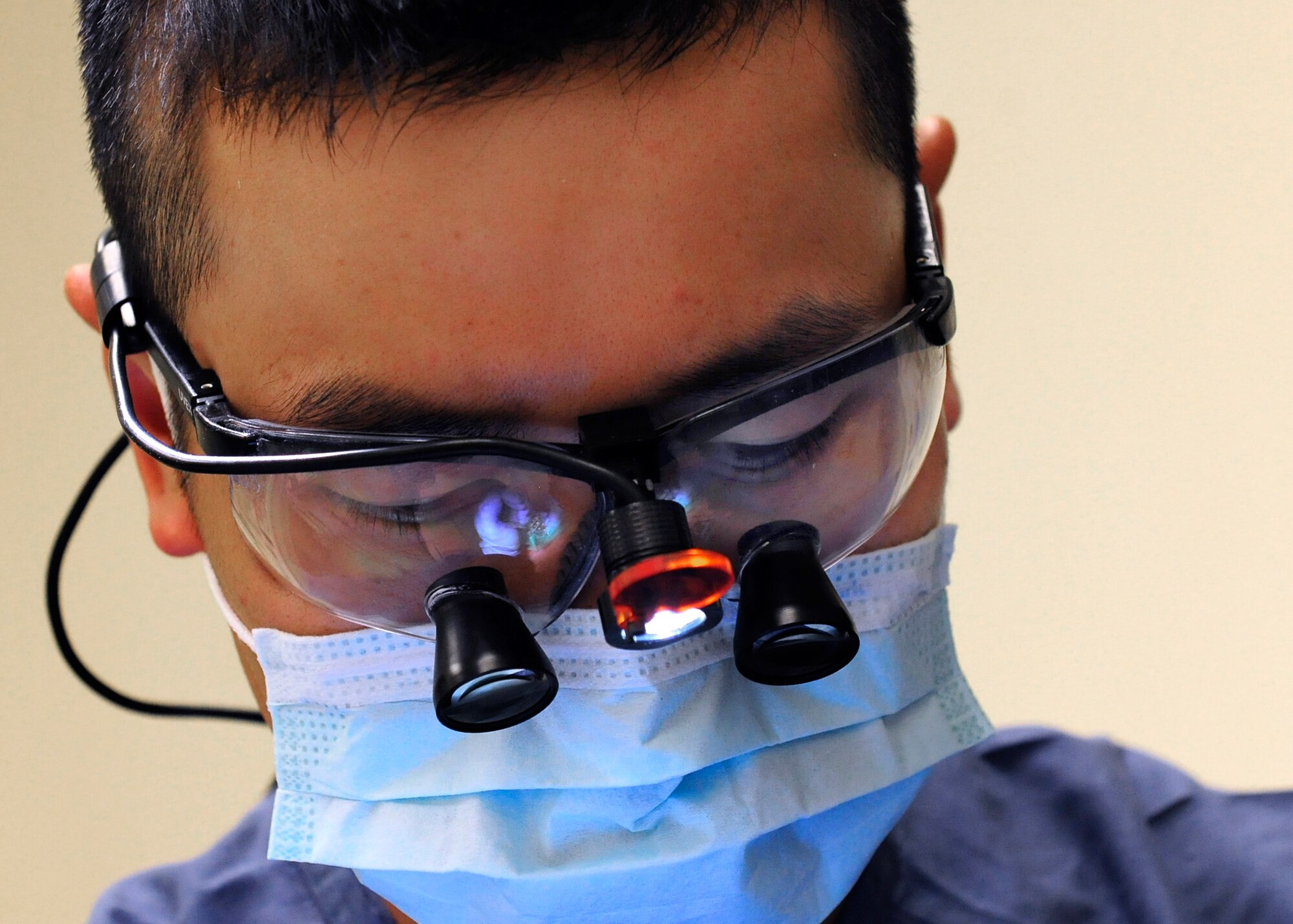 Capt. Duy Nguyen, 31st Dental Squadron general dentist, performs a routine cleaning during an annual checkup, June 19, 2014, at Aviano Air Base, Italy. The 31st Dental Squadron’s primary duties are to treat patients and provide dental care to approximately 9,200 beneficiaries spanning three geographically-separated units under a space-available mission. (U.S. Air Force photo/Airman 1st Class Ryan Conroy) 