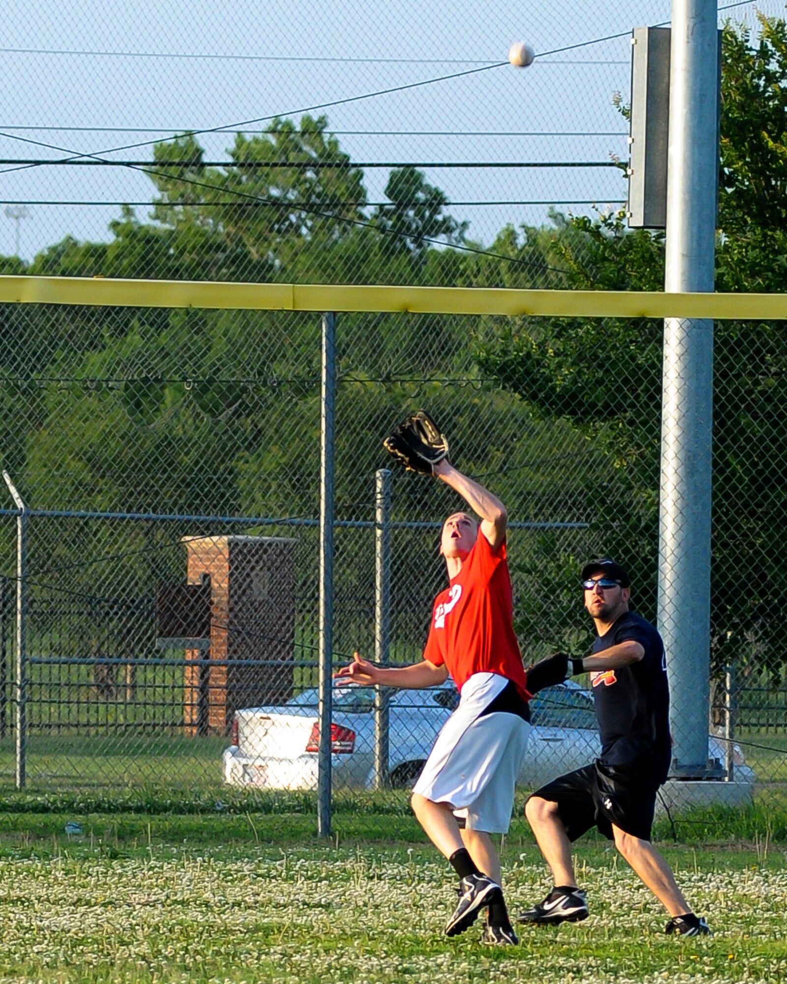 Tech. Sgt. Robert Mills tracks down a fly to left with center fielder Allan Smith backing the play up.  The Okies came up short to the Navy's VQ-7 Roughnecks 14-0 Thursday June 26.  The Okies next game is slated for July 10.  (U.S. Air Force photo/Senior Airman Mark Hybers)