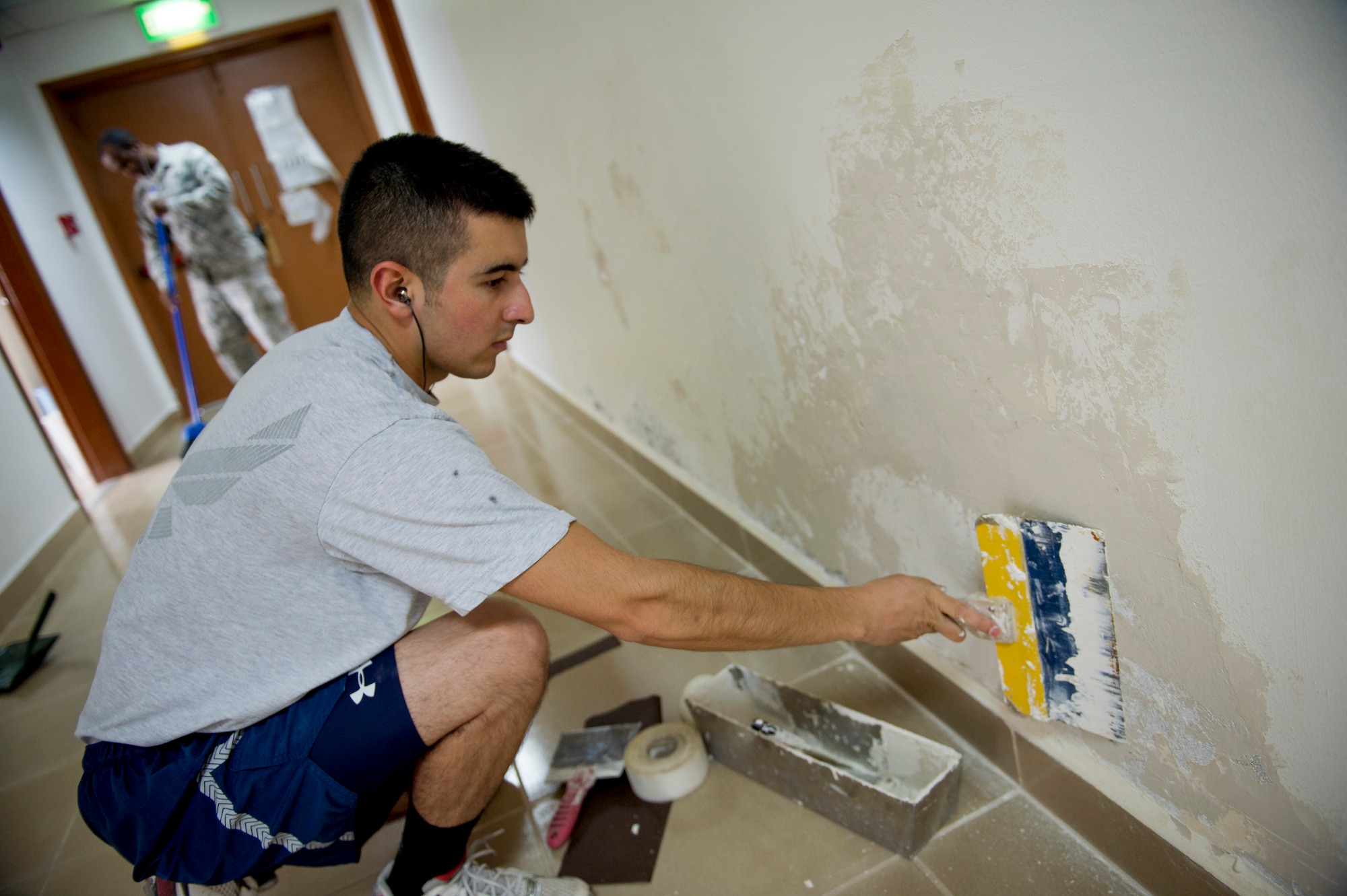 U.S Air Force Senior Airman David Nunez, 386th Expeditionary Civil Engineer Squadron heating, ventilation, and air condition technician, repairs a wall as part of a base dormitory renovation June 12, 2014 at an undisclosed location in Southwest Asia. Nunez is deployed from the 146th Civil Engineer Squadron, Channel Islands Air National Guard Station, California. A total of 23 dorms are scheduled to be renovated by the end of the year. (U.S. Air Force photo by Staff Sgt. Jeremy Bowcock)