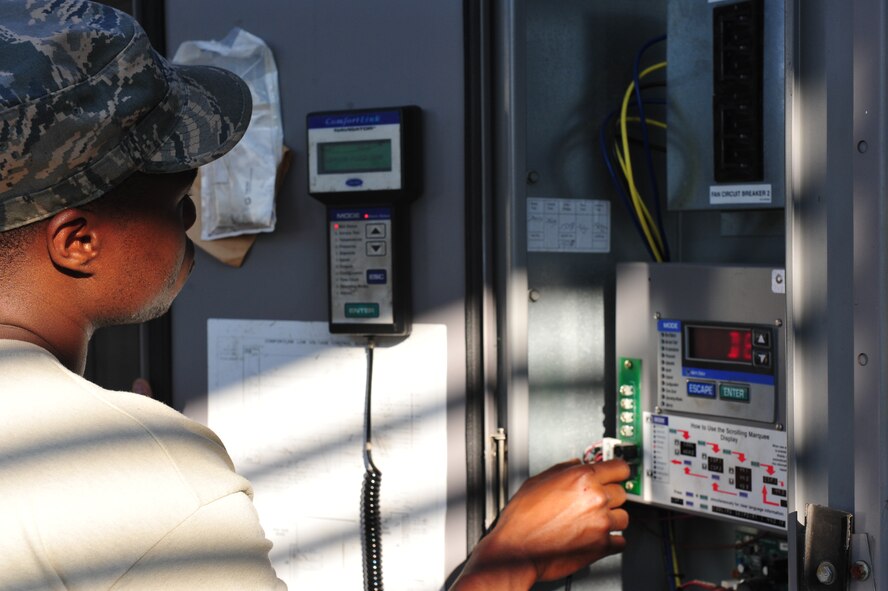 Staff Sgt. Wava Johnson, 8th Civil Engineer Squadron Heating, Ventilation, Air Conditioning and Refrigeration shop craftsman, uses a Comfortlink to navigate through the controls of an air chiller at Kunsan Air Base, Republic of Korea, June 30, 2014. Johnson was troubleshooting a malfunctioning chiller unit discovered while performing routine maintenance. Routine maintenance is crucial in reducing an already high work load for the HVAC shop. (U.S. Air Force photo by 1st Lt. Earon Brown/Released)