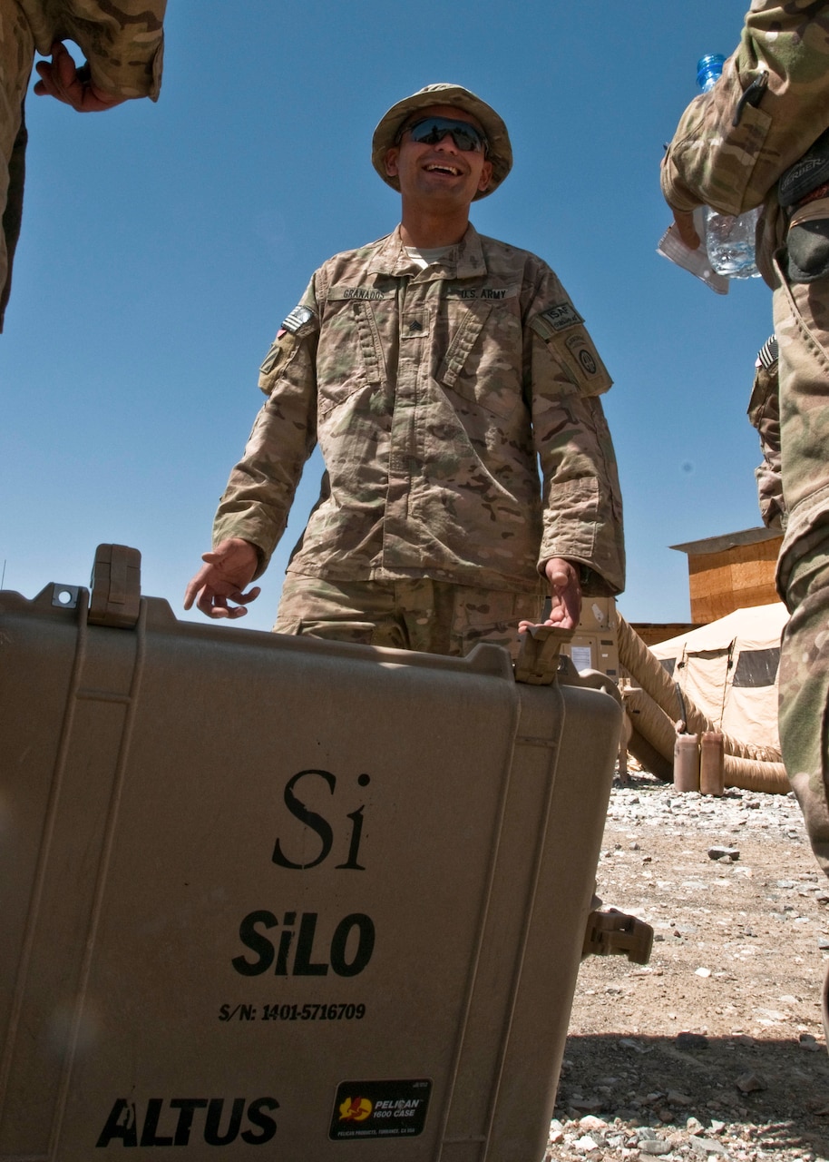 Army Sgt. Fabricio Granados jokes with fellow soldiers after fixing a generator on Forward Operating Base Sweeney, Afghanistan, June 19, 2014. U.S. Army photo by Staff Sgt. Whitney Houston