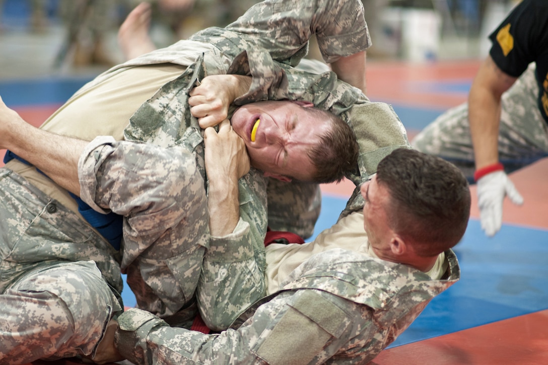 Army Reserve Cpls. Jabriel Santos, right, and Francis Kvarta fight for a dominating position during the Modern Army Combatives tournament during the 2013 U.S. Army Reserve Best Warrior Competition on Fort McCoy, Wis., June 27, 2014. 