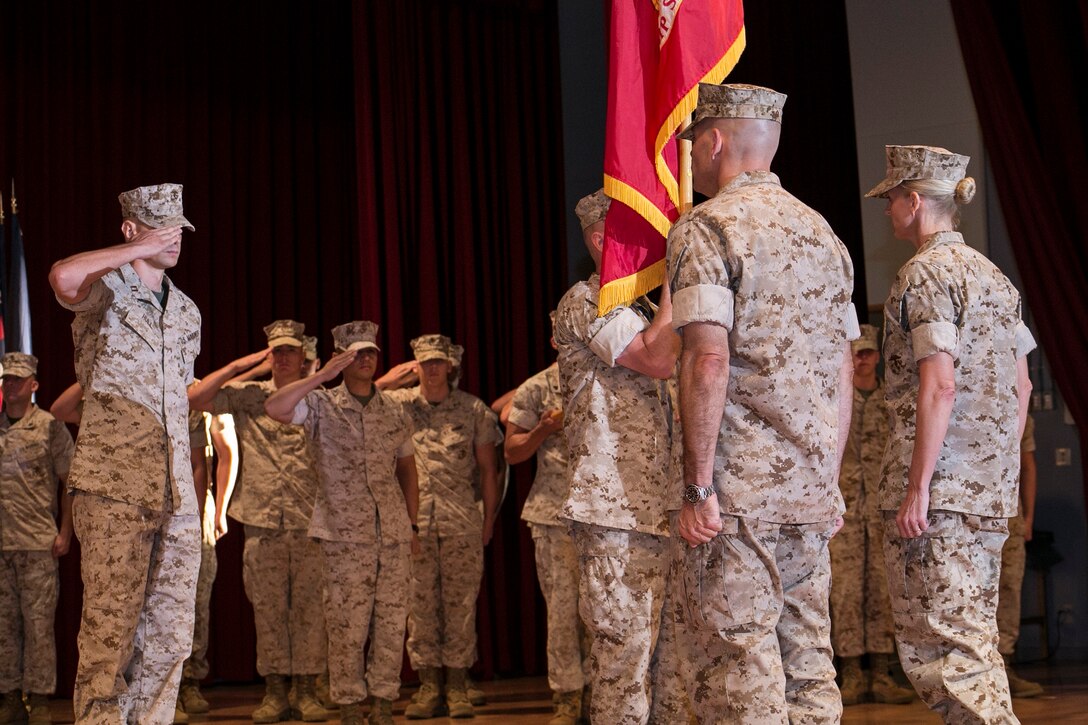 Col. Katherine J. Estes, far right, prepares to relinquish command of Headquarters and Support Battalion to Col. Thomas A. Pecina, second from right, June 30 at the Camp Foster Community Center. Estes, a Marceline, Missouri, native, began her two-year term as commanding officer in June 2012. Pecina, a Lubbock, Texas, native, assumed command of the battalion. The battalion is part of Marine Corps Installations Pacific-Marine Corps Base Camp Butler. 