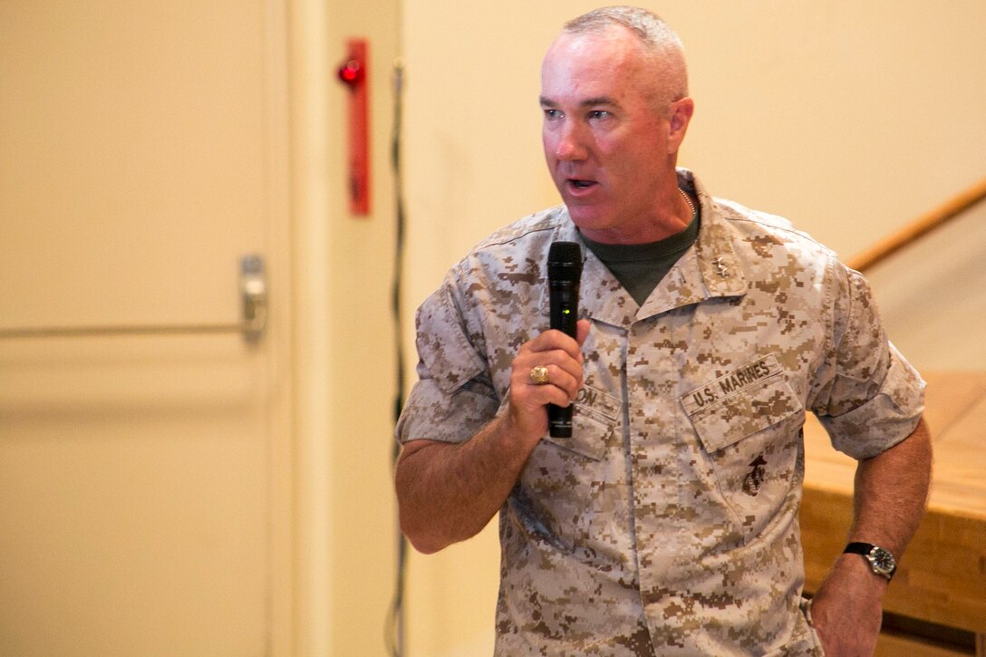 Maj. Gen. Charles L. Hudson, a Butler, Pennsylvania, native, offers words of encouragement to Cols. Katherine J. Estes and Thomas A. Pecina June 30 during a change of command ceremony at the Camp Foster Community Center. The event signifies the end of Estes’ two-year term as commanding officer for Headquarters and Support Battalion. Pecina, a Lubbock, Texas, native, assumed command of the battalion. The battalion is part of Marine Corps Installations Pacific-Marine Corps Base Camp Butler. Hudson is the commanding general of MCIPAC-MCB Camp Butler. 