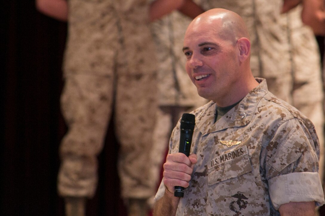 Col. Thomas A. Pecina, a Lubbock, Texas, native, offers words of encouragement and gratitude June 30 at the Camp Foster Community Center during a ceremony marking the beginning of his two-year term as commanding officer of Headquarters and Support Battalion. Pecina is picking up the proverbial torch from Col. Katherine J. Estes, a Marceline, Missouri, native. The battalion is part of Marine Corps Installations Pacific-Marine Corps Base Camp Butler. 