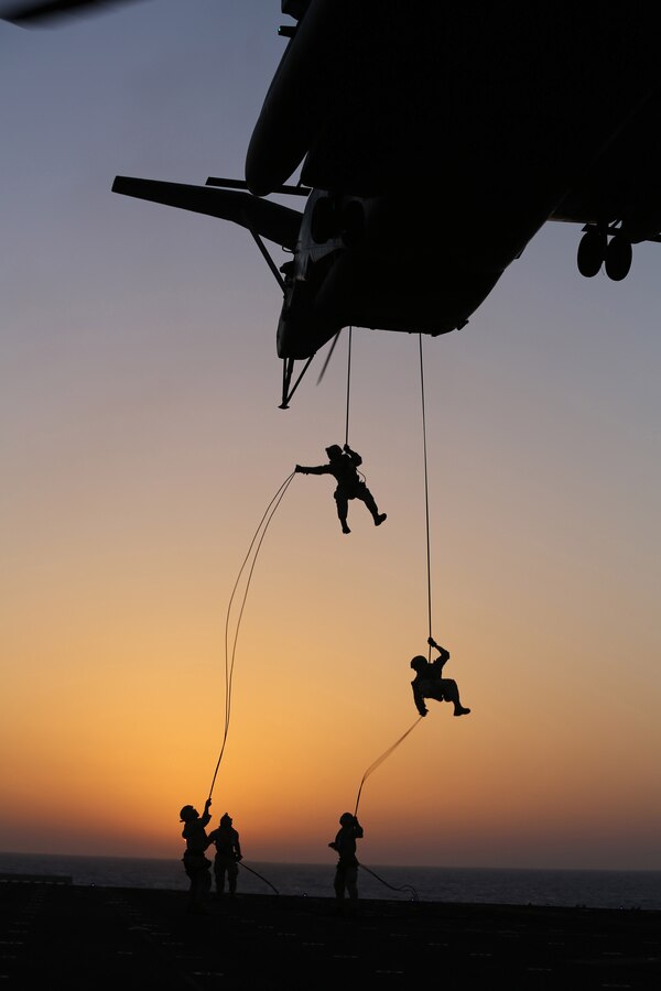 U.S. Marines with Battalion Landing Team 1st Battalion, 6th Marine Regiment, 22nd Marine Expeditionary Unit (MEU), rappel out of a CH-53E Super Stallion helicopter during a fast rope and rappel training exercise aboard the USS Bataan (LHD 5), at sea, June 24, 2014. Elements of the 22nd MEU, embarked aboard Bataan, are operating in the U.S. 6th Fleet area of operations to augment U.S. Crisis Response forces in the region. (U.S. Marine Corps photo by Sgt. Alisa J. Helin/Released)