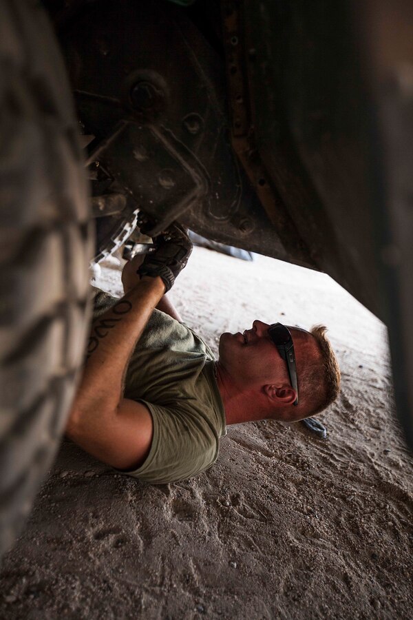 U.S. FIFTH FLEET AREA OF RESPONSIBILITY (June 28, 2014) U.S. Marine Corps Cpl. Adam Roberts, Combat Logistics Battalion 22, 22nd Marine Expeditionary Unit (MEU), motor transportation mechanic and native of Brookline, Mass., replaces a Humvee steering gear. The 22nd MEU is deployed with the Bataan Amphibious Ready Group as a theater reserve and crisis response force throughout U.S. Central Command and the U.S. 5th Fleet area of responsibility. (U.S. Marine Corps photo by Sgt. Austin Hazard/Released)