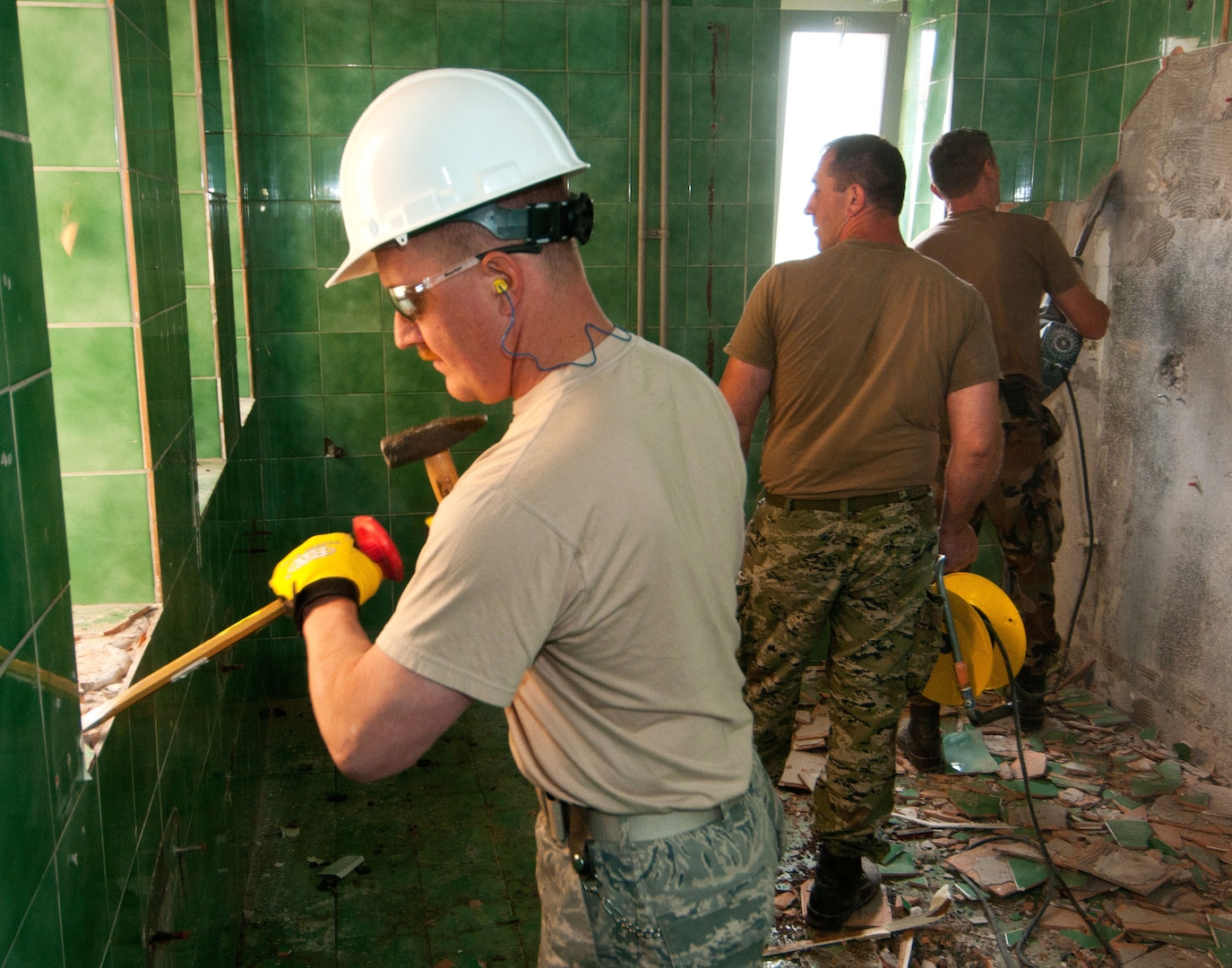 U.S. Air Force Master Sgt. Steven Virnig, 133rd Civil Engineering Squadron, removes tile from an elementary school bathroom in Ogulin, Croatia, June 17, 2014. The school bathrooms are being renovated by Airmen from the 133rd and 148th Civil Engineering Squadron, and 219th Red Horse Squadron in partnership with the Croatian Army. Croatia is a Minnesota State Partner under the National Guard State Partnership Program. 
