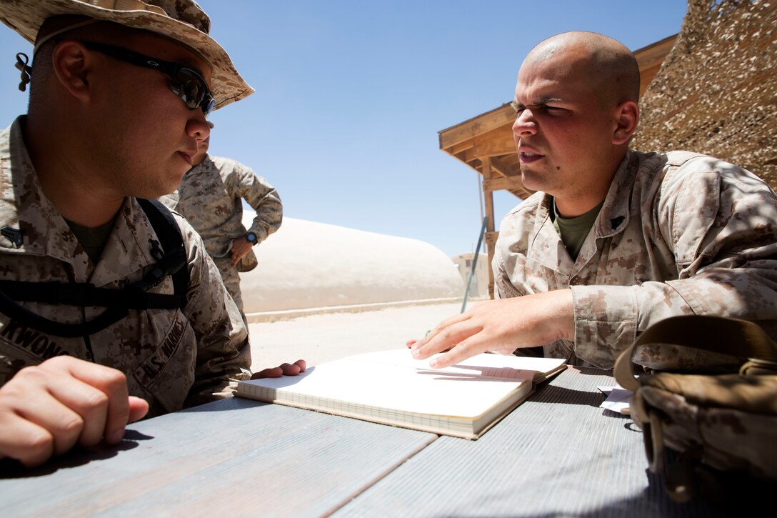 Cpl. Michael Kean, a landing support specialist with Combat Logistics Regiment 45, discusses the instructions for the day with a fellow Marine during Integrated Training Exercise 4-14 June 16, 2014. ITX 4-14 is a cornerstone of the Marine Air-Ground Task Force Training Program and is the largest annual Marine Corps Reserve training exercise that helps sharpen skills for Reserve units. ITX employs assets from ground, air and logistics combat elements to demonstrate the ability to deploy rapidly and build up significant combat power necessary to form a MAGTF. Kean hopes to one day become a Marine officer after gaining more experience leading Marines as a noncommissioned officer.