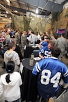 Three players from the Indianapolis Colts, as well as players from the Cleveland Browns, Tennessee Titans, Carolina Panthers, and the New York Jets sign autographs for Soldiers and their families at the NFL Salute to Service military appreciation event at the Camp Atterbury Joint Maneuver Training Center in Edinburgh, Ind., Feb. 2, 2012.