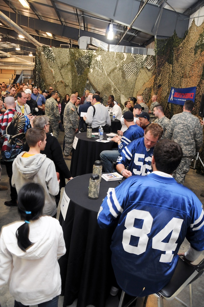 Three players from the Indianapolis Colts, as well as players from the Cleveland Browns, Tennessee Titans, Carolina Panthers, and the New York Jets sign autographs for Soldiers and their families at the NFL Salute to Service military appreciation event at the Camp Atterbury Joint Maneuver Training Center in Edinburgh, Ind., Feb. 2, 2012.