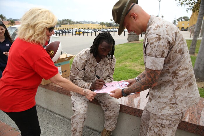Charles Tillman, cornerback for the Chicago Bears of the National Football League, signs autographs for the Marines aboard Marine Corps Recruit Depot San Diego, July 1. Not only did the Marines enjoy spending time with the professional football player, but Tillman said he enjoyed touring the base and socializing with the Marines aboard the depot.