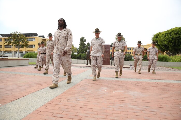 Charles Tillman, cornerback for the Chicago Bears of the National Football League, marches with marines in front of the Drill Instructor Monument aboard Marine Corps Recruit Depot San Diego, July 1. The gounds of the Drill Instructor Monument is laid with inscribed bricks containing the names of former drill instructors.  One was very special to Tillman - his father-in-law's name. 