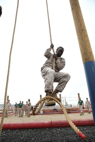 Charles Tillman, cornerback for the Chicago Bears of the National Football League, runs the Obstacle Course aboard Marine Corps Recruit Depot San Diego, July 1. Once Tillman completed the obstacle course he autographed footballs and spoke with the Marines.