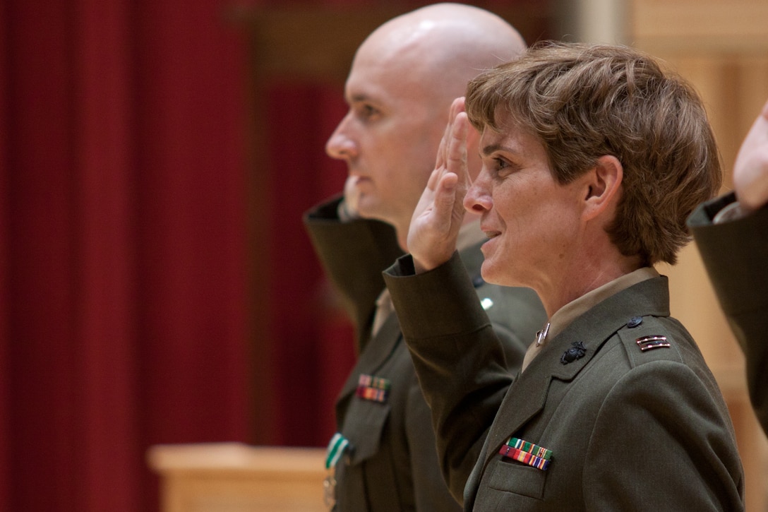 In a ceremony on July 3, 2014, at John Philip Sousa Band Hall at Marine Barracks Annex in Washington, D.C., Col. Michael J. Colburn promoted Jason K. Fettig to Lieutenant Colonel, Michelle A. Rakers to Major, and commissioned Ryan J. Nowlin to 1st Lieutenant. (U.S. Marine Corps photo by Staff Sgt. Brian Rust/released)
