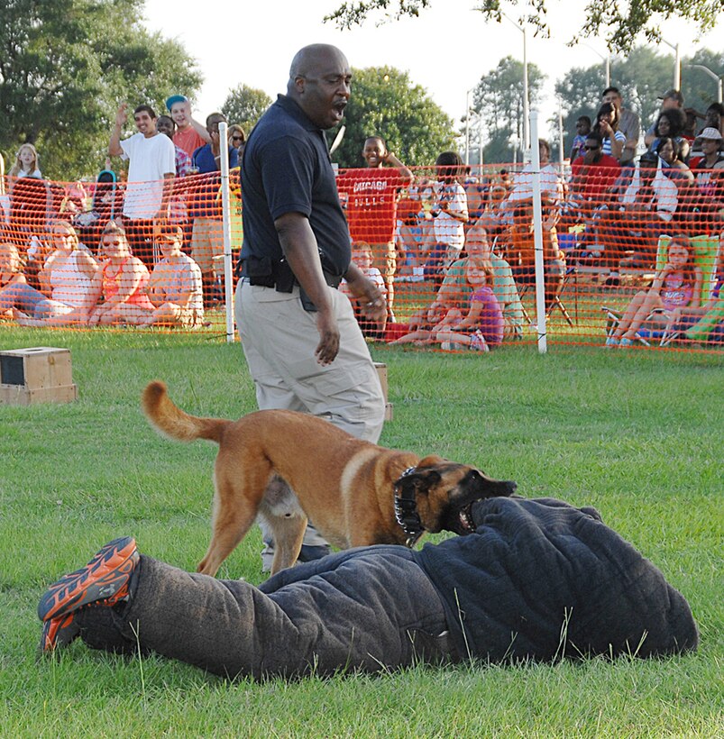 Pablo, a Belgian Malinois, chases and attacks Cpl. Erin Zupko, civilian working dog handler, K-9 section, Marine Corps Police Department, Marine Corps Logistics Base Albany, during a military working dog demonstration at MCLB Albany’s annual Independence Day celebration, here, June 27. 