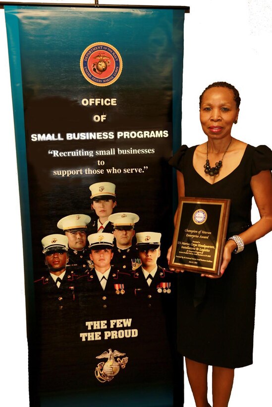 Hattie Mosely, director, Small Business Program Office, Marine Corps Logistics Command, displays the Champions of Veteran Enterprise Award she accepted on behalf of Headquarters Marine Corps’ Installations and Logistics June 17 at the 2014 Veteran Entrepreneur Training Symposium. 