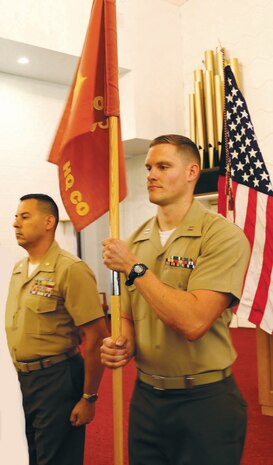 Capt. Thomas F. Cutsinger (right), accepts the guidon from Maj. Alexander J. Vanston at the Headquarters Company East’s change of command ceremony held at the Marine Corps Logistics Base Albany’s Base Chapel Annex, Friday. Vanston will take over as Marine Corps Logistics Command's staff secretary.
