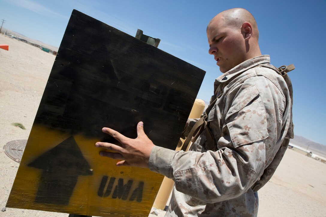 Cpl. Michael Kean, a landing support specialist with Combat Logistics Regiment 45, prepares a sign detailing the direction of the unit marshalling area during Integrated Training Exercise 4-14 June 16, 2014. ITX 4-14 is a cornerstone of the Marine Air-Ground Task Force Training Program and is the largest annual Marine Corps Reserve training exercise that helps sharpen skills for Reserve units. ITX employs assets from ground, air and logistics combat elements to demonstrate the ability to deploy rapidly and build up significant combat power necessary to form a MAGTF. Kean hopes to one day become a Marine officer after gaining more experience leading Marines as a noncommissioned officer.