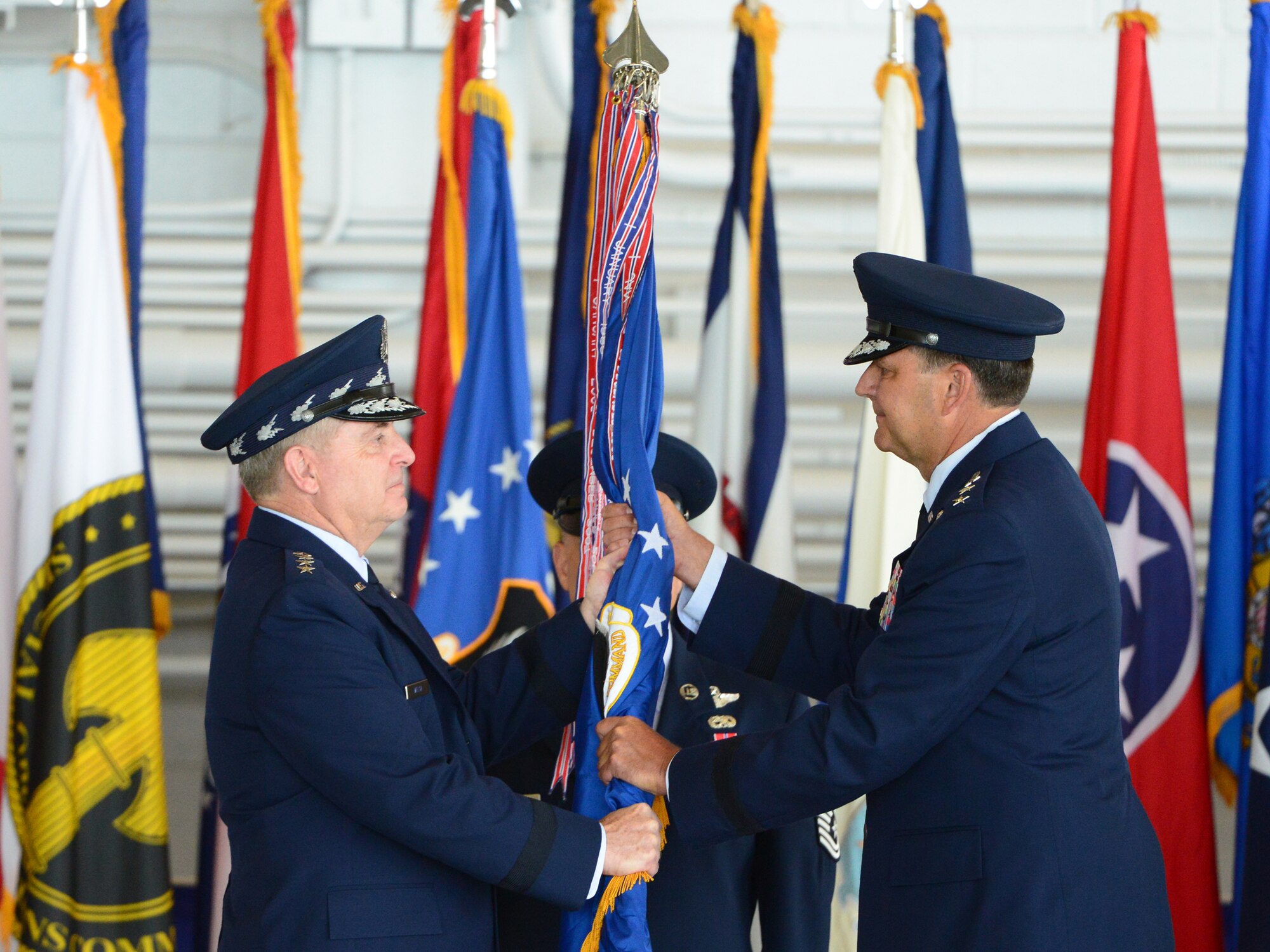 Air Force Chief of Staff Gen. Mark A. Welsh III and Lt. Gen. Bradley A. Heithold pass the Air Force Special Operations Command guidon, making Heithold the 10th commander of AFSOC, during a change of command ceremony held at Hurlburt Field, Fla., July 3, 2014.  Heithold becomes the AFSOC commander after a three-year tour as the headquarters U.S. Special Operations Command vice commander in Washington, D.C.  (U.S. Air Force photo by Master Sgt. Steven Pearsall)