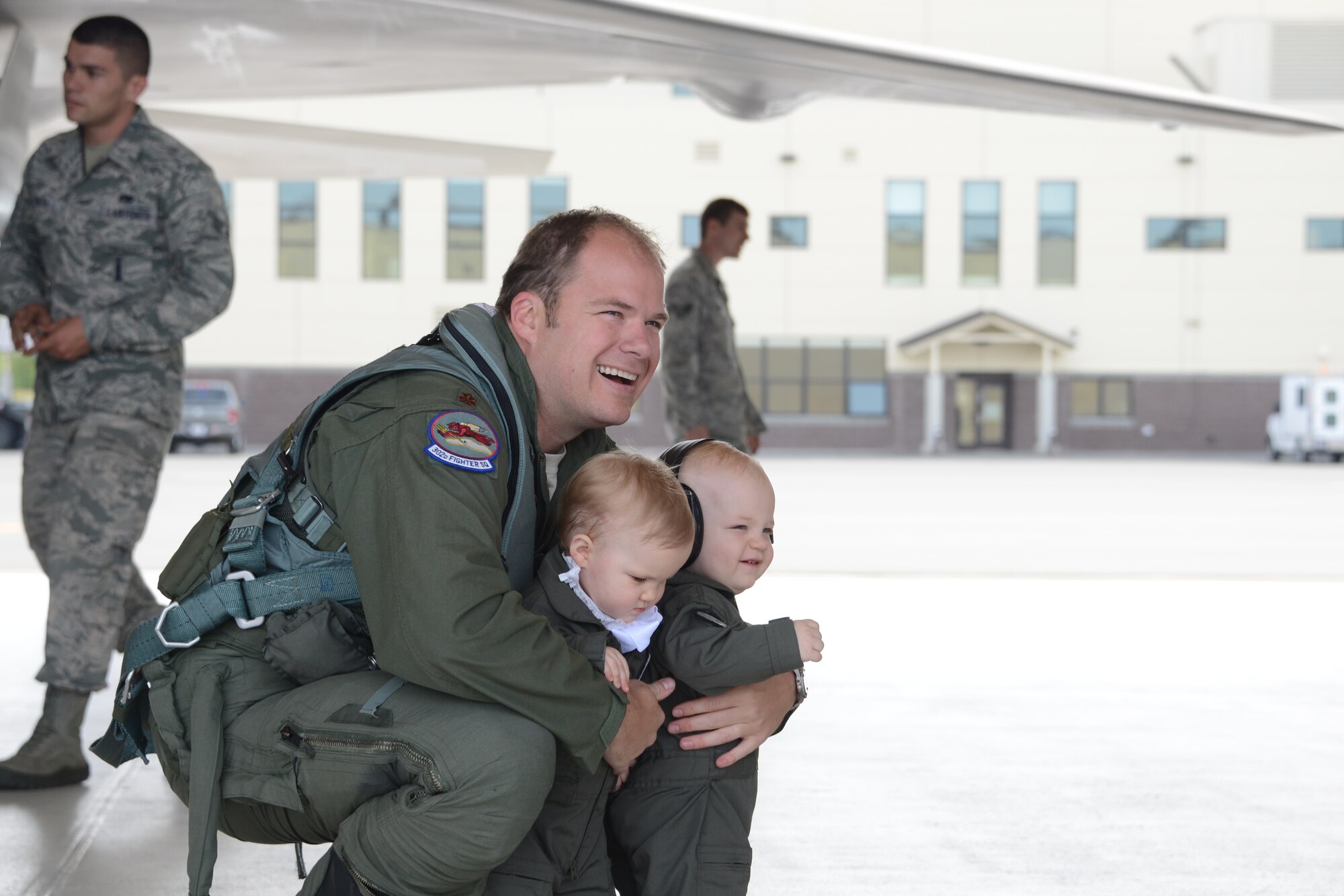 Upon landing Maj. Jonathan Gration, Reserve F-22 pilot assigned to the 302nd Fighter Squadron, is congratulated by his twin 1 year olds, Jack and Madeline. This flight marked Gration’s 1,000 flight hour in the F-22 making him only the fourth Air Force pilot to reach this milestone. (U.S. Air Force photo/Tech. Sgt. Dana Rosso)