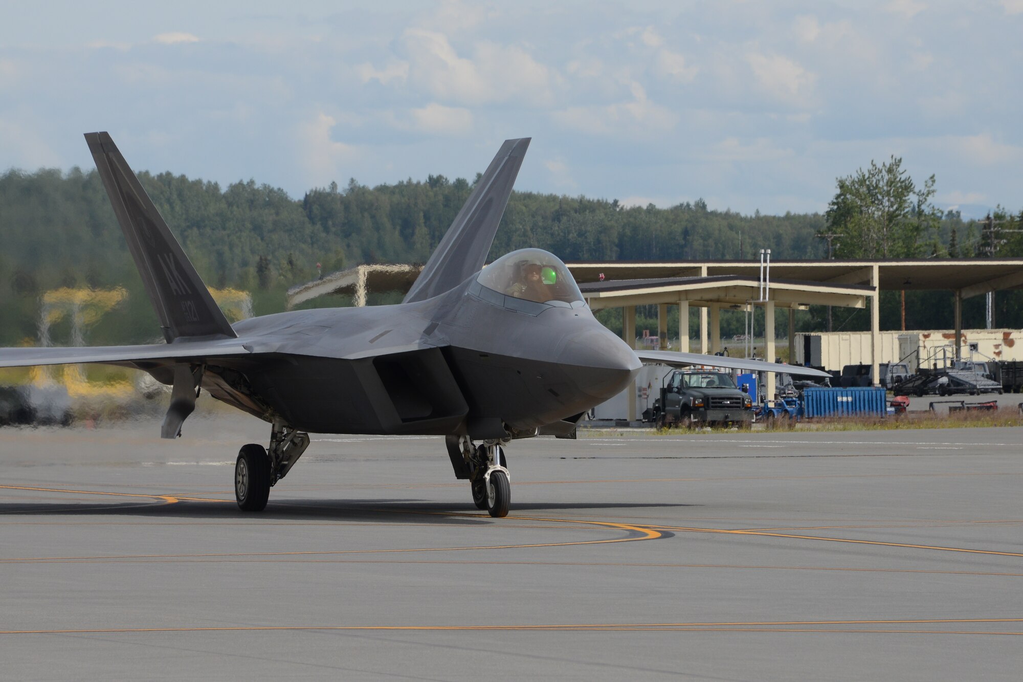 Maj. Jonathan Gration, Reserve F-22 pilot assigned to the 302nd Fighter Squadron, taxies back to the aircraft parking location after landing here July 3. This flight marked Gration’s 1,000 flight hour in the F-22 making him only the fourth Air Force pilot to reach this milestone. (U.S. Air Force photo/Tech. Sgt. Dana Rosso)