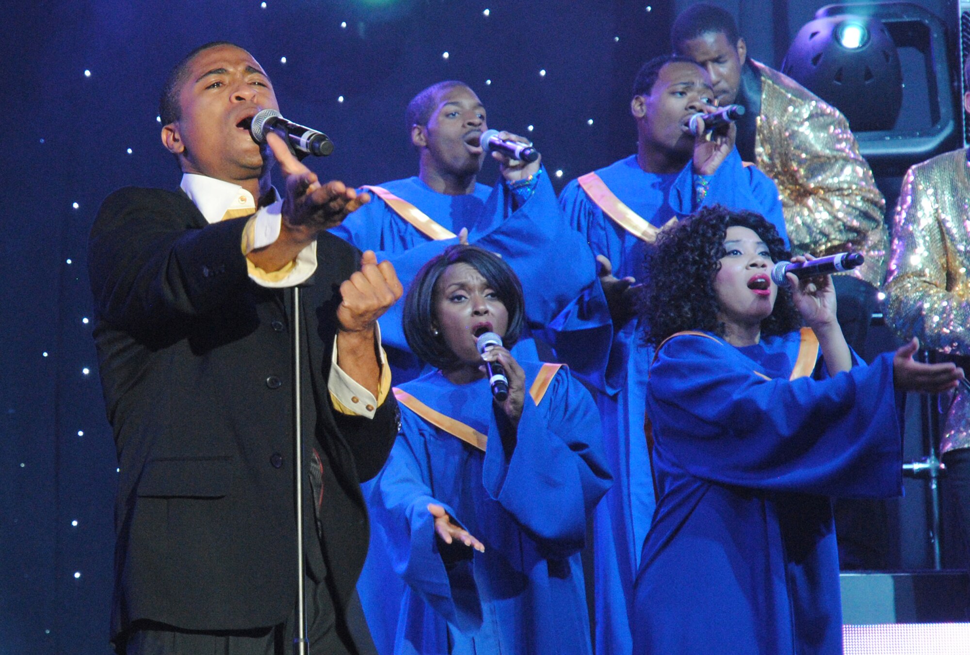 Vocalist, Senior Airman Charles Cooper's, sings “All of me,” June 29, 2014, at the Chester Fritz Auditorium in Grand Forks, N.D. This year's Tops in Blue performance  featured some songs by popular modern-day artists and groups such as “The story of my Life,” by British boy-band, 1-Direction, and “Mirrors,” by Justin Timberlake; however, it was Cooper’s vocal performance of John Legend’s love ballad, “All of me,” that drew the most cheers from the ladies in the crowd. (U.S. Air Force photo/Staff Sgt. Luis Loza Gutierrez)
