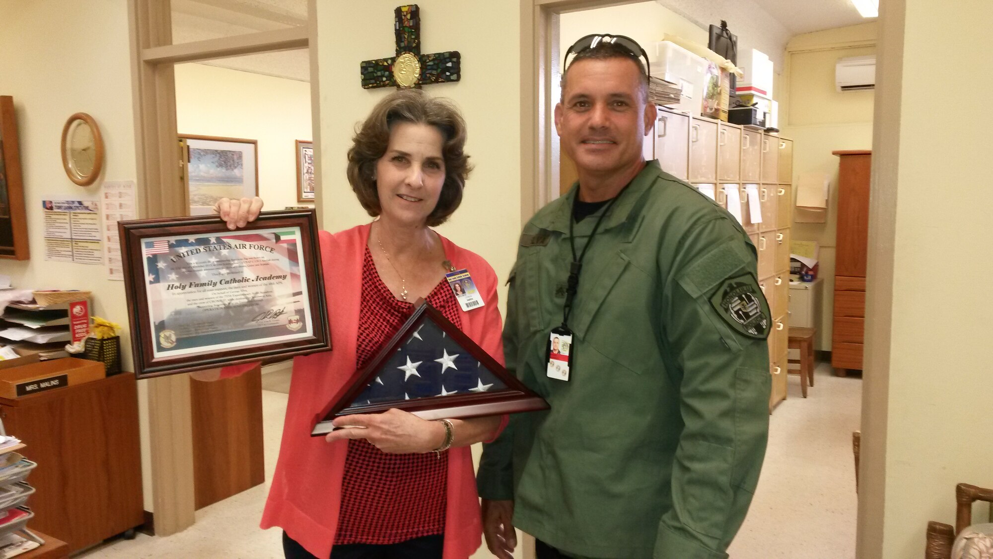 Chief Master Sgt. George Silva III, right, aerial port operations superintendent with the 48th Aerial Port Squadron, 624th Regional Support Group, Joint Base Pearl Harbor-Hickam, Hawaii, poses for a photo with the principal of a local elementary school, left, June 4, 2014. Silva brought gifts to the school upon return from deployment in appreciation for the care packages the students sent to him and his troops in the desert. (Courtesy photo/Master Sgt. Peter Rieta)
