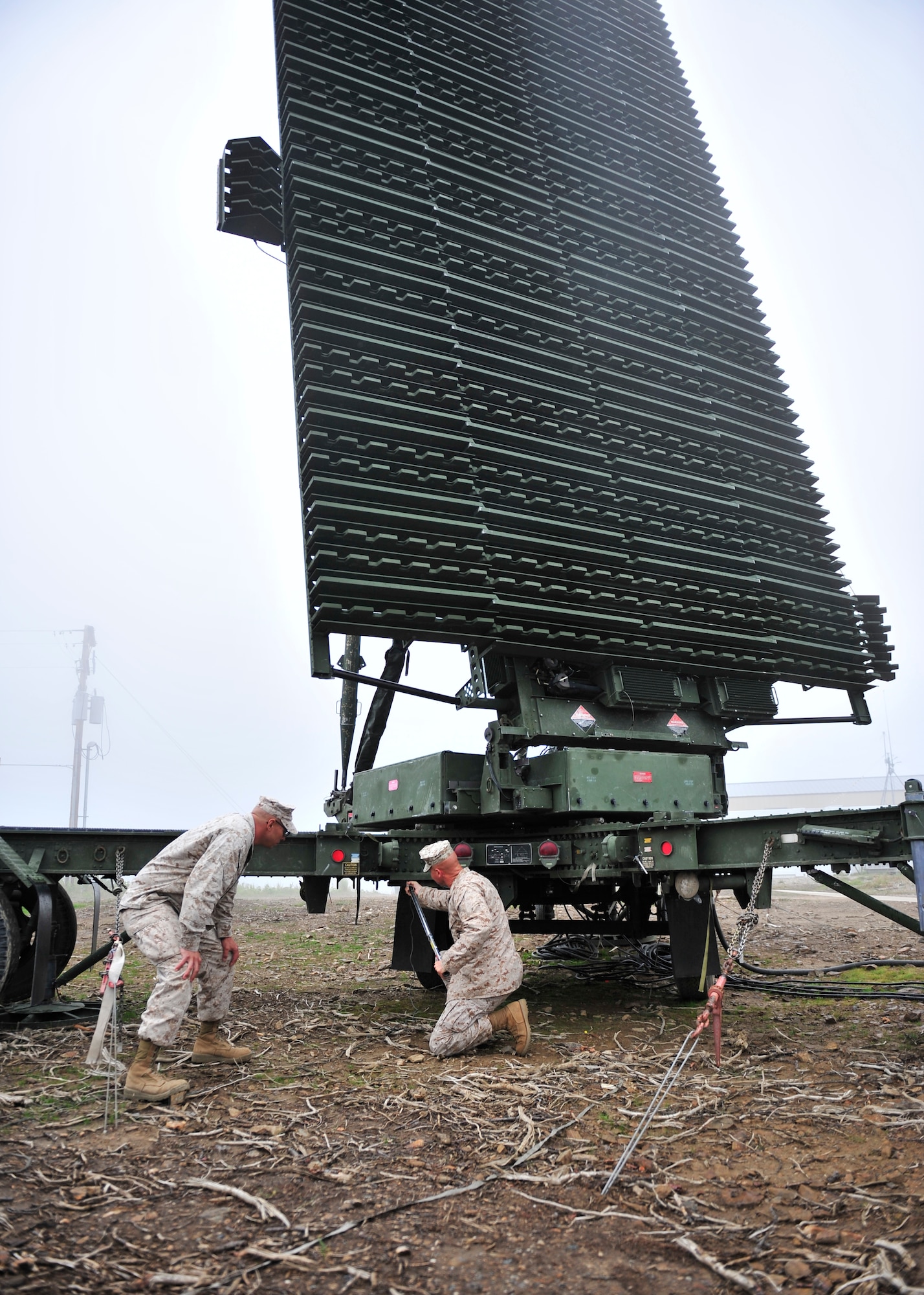 U.S. Marine Corps Gunnery Sgt. Alfredo Franco,  Marine Air Control Squadron 2, and Chief Warrant Officer 2 James Haunty, MACS-2 maintenance officer both assigned to Marine Corps Air Station Cherry Point, N.C., torque swing bolts on an AN/TPS-59 long range radar during Red Flag-Alaska 14-2 June 24, 2014, Joint Pacific Alaska Range Complex, Alaska. The AN/TPS-59 is a 3-D radar that detects an aircraft’s height and altitude to positively control them and find hostile aircraft. (U.S. Air Force photo by Senior Airman Ashley Nicole Taylor/Released)